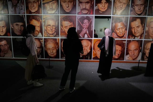 Women visit a photography exhibition showcasing works by international photographers from the collection of the Tehran Museum of Contemporary Art