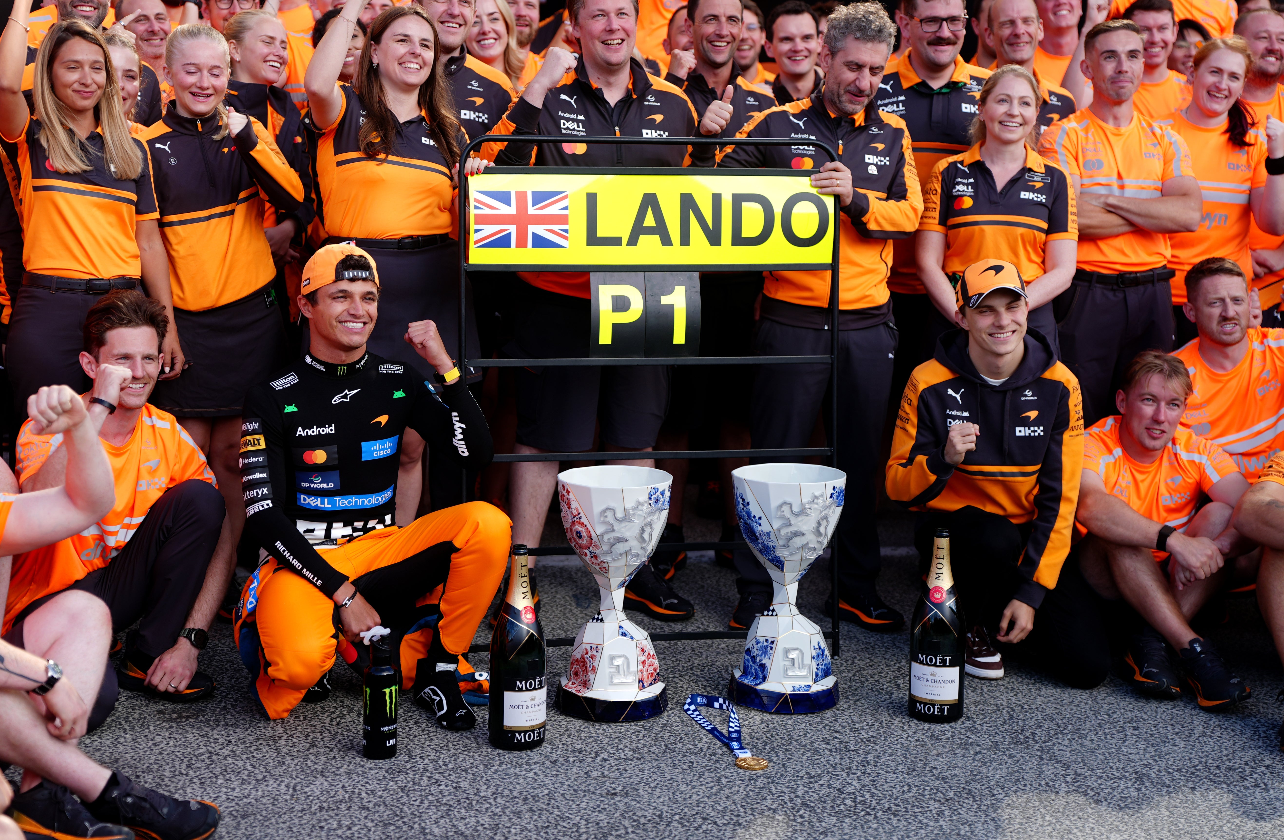 Norris celebrates with his McLaren team (David Davies/PA)