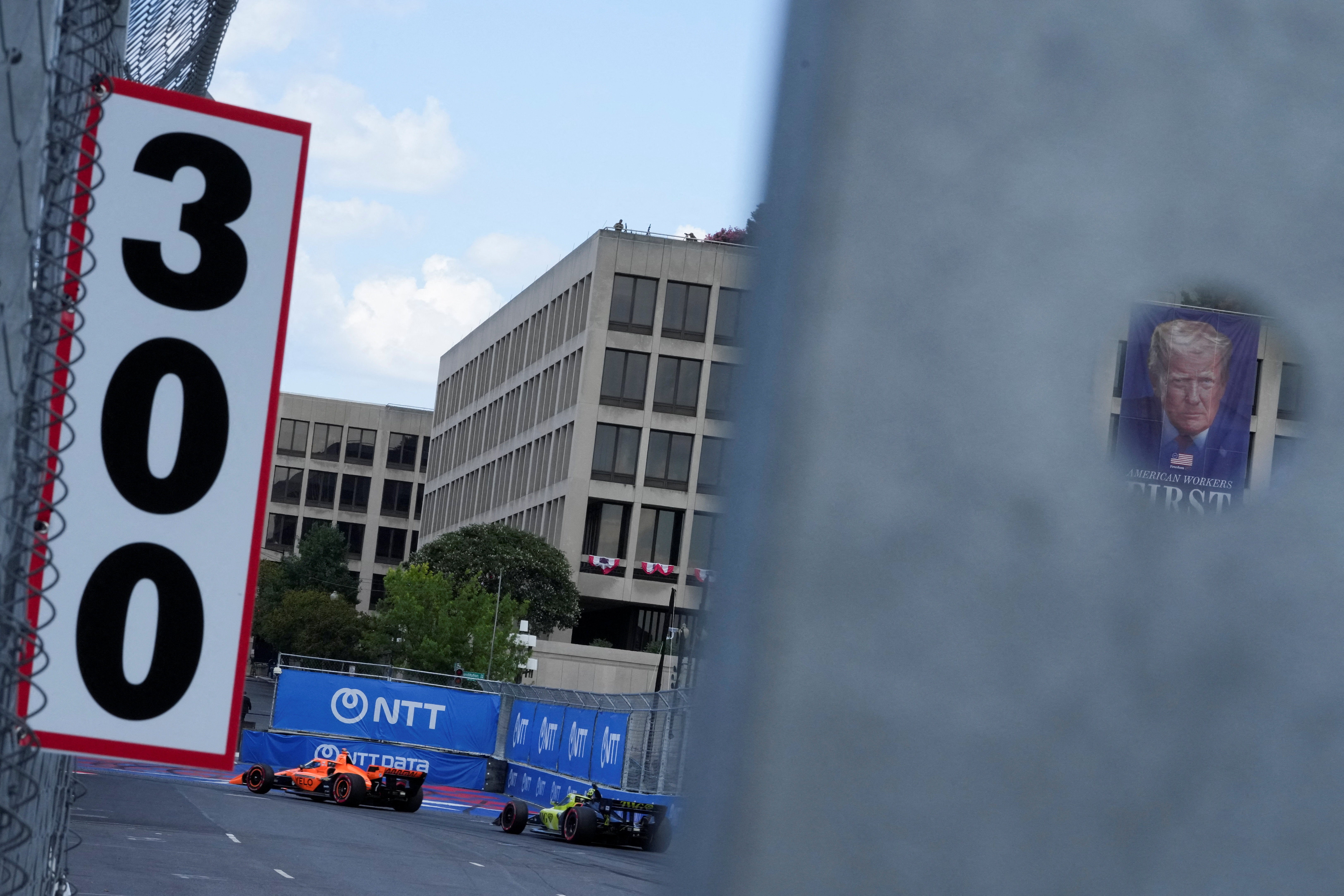 A poster of U.S. President Donald Trump as drivers take part in the Freedom 250 Grand Prix IndyCar Series race