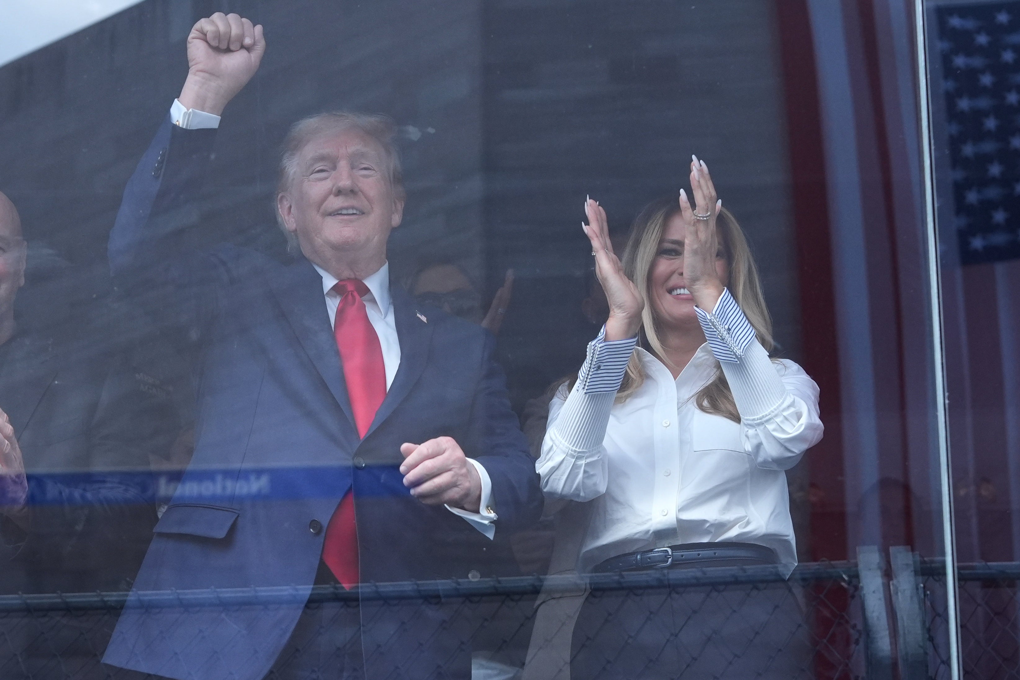 President Donald Trump and first lady Melania Trump cheer after Kyle Kirkwood wins (AP)