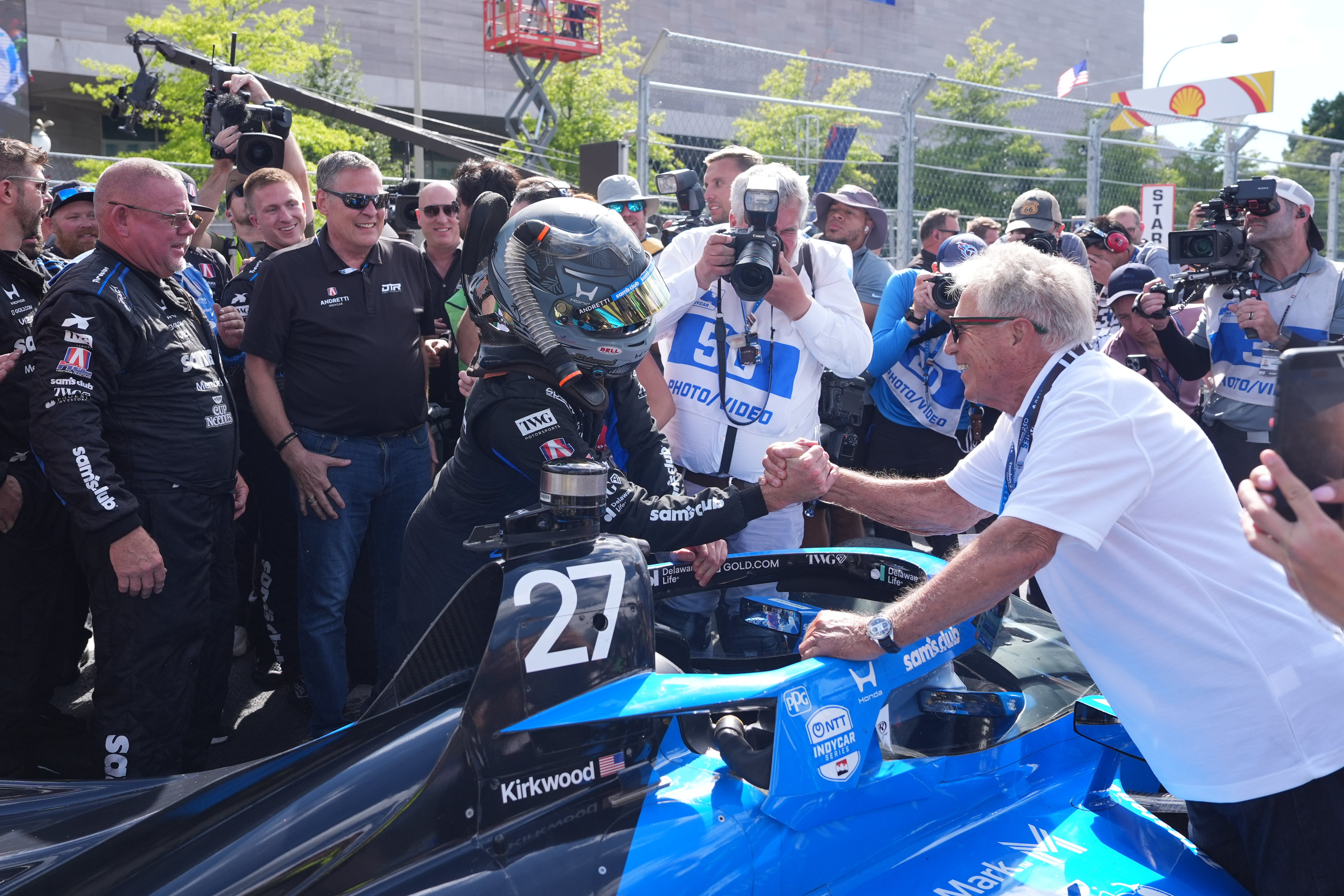 Mario Andretti greets driver Kyle Kirkwood  after he won the IndyCar Freedom 250 Grand Prix auto race (AP)