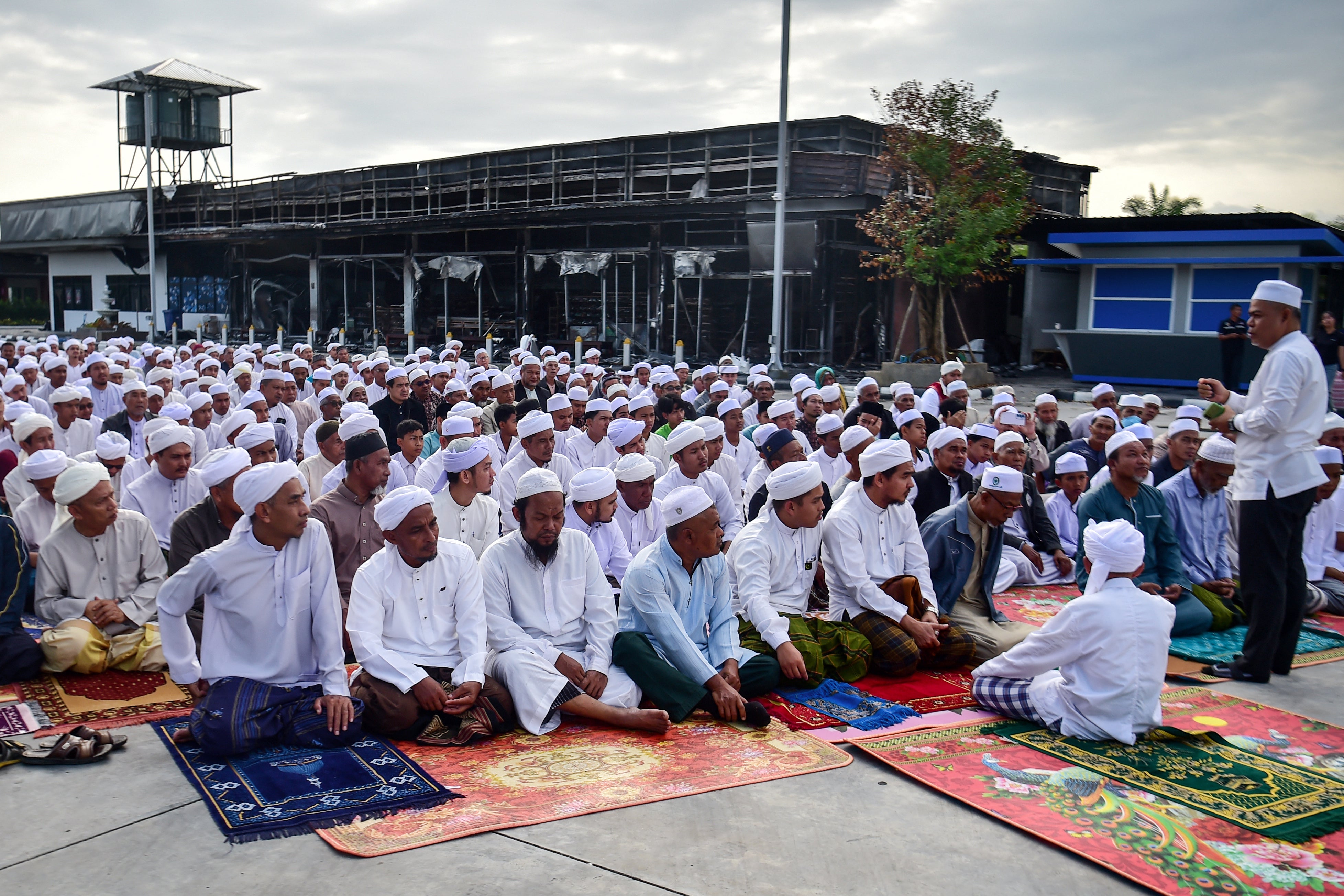 File: Members of the Thai Muslim community take part in prayers next to a damaged petrol station days after a bomb attack in Thailand's southern province of Narathiwat in Jan 2026