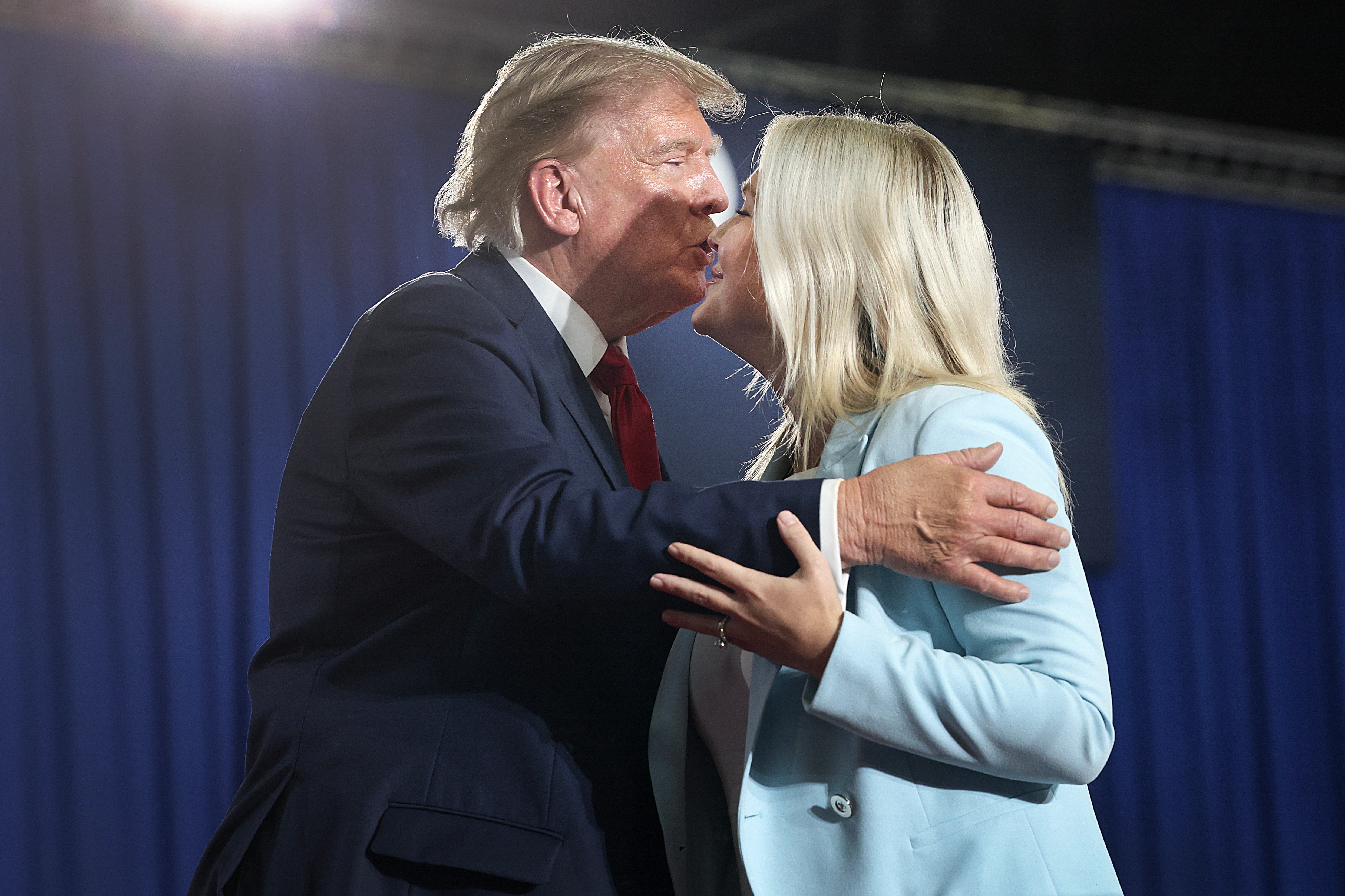 Trump greets Press Secretary Karoline Leavitt during a campaign rally with U.S. Sen. Darline Graham (R-SC) on August 21