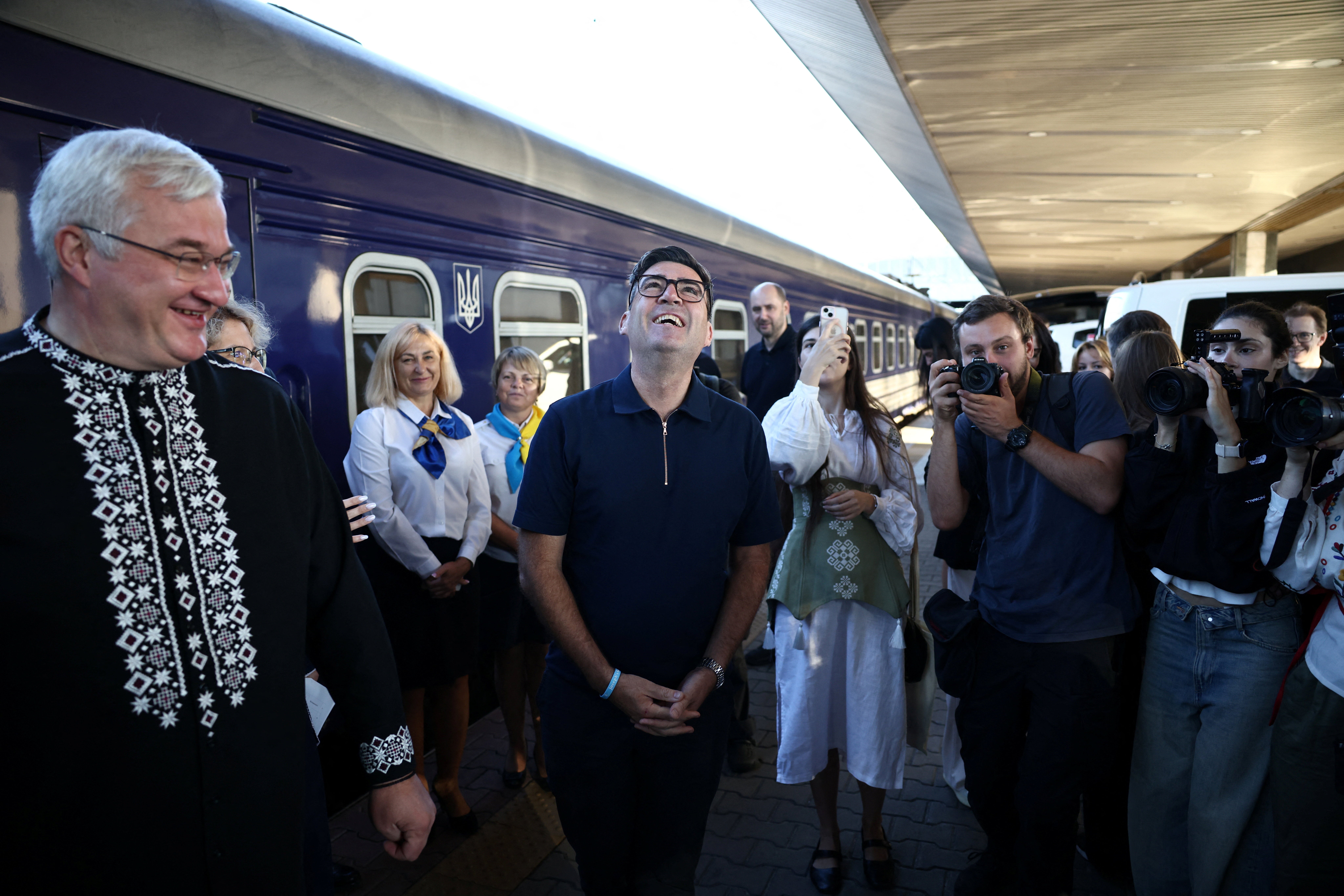 Andy Burnham greets the Ukrainian officials upon his arrival by train in Kyiv