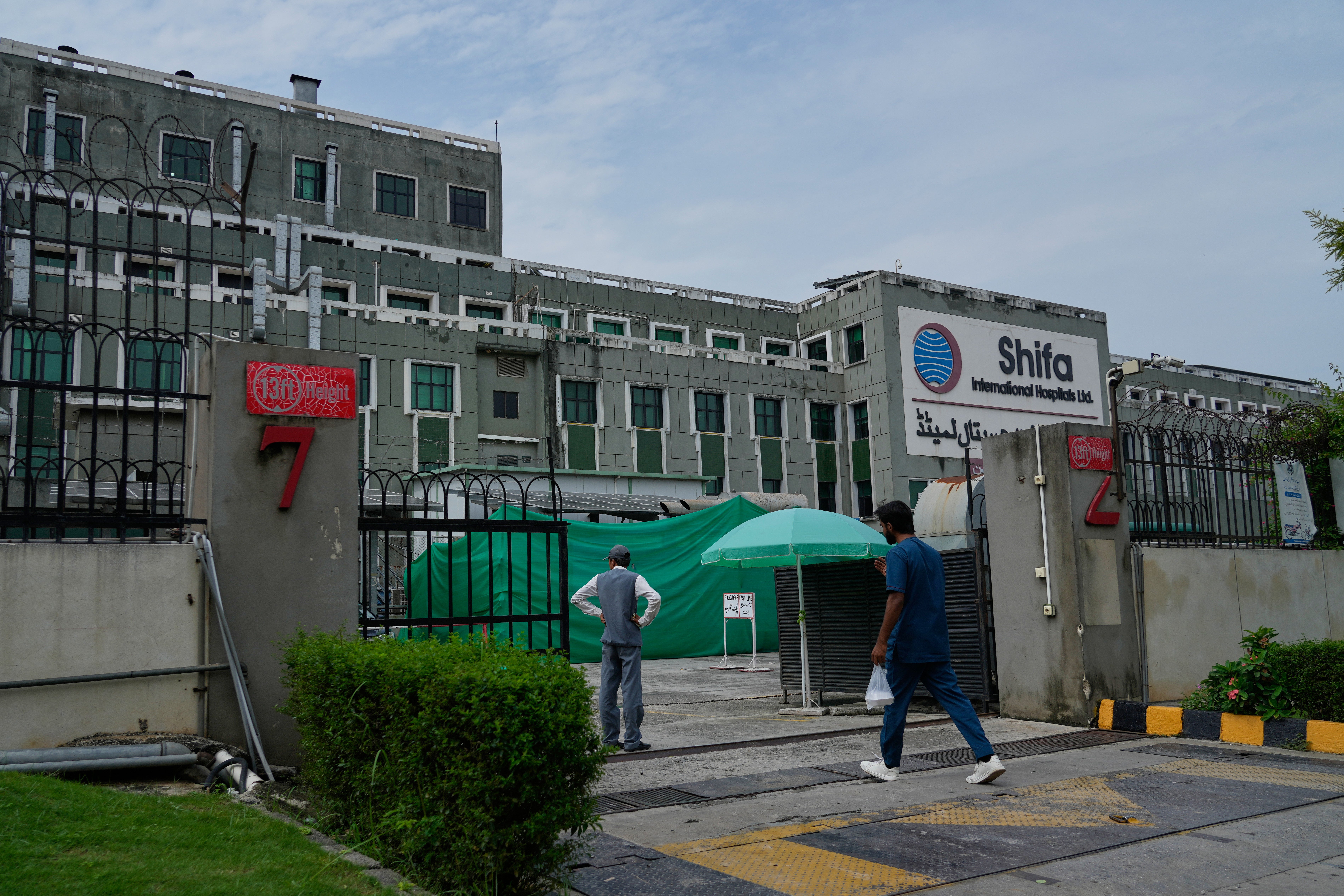 A medical person enters Shifa International Hospital, where imprisoned former PM Imran Khan will be transferred for a medical examination following Pakistan's Supreme Court order in Islamabad