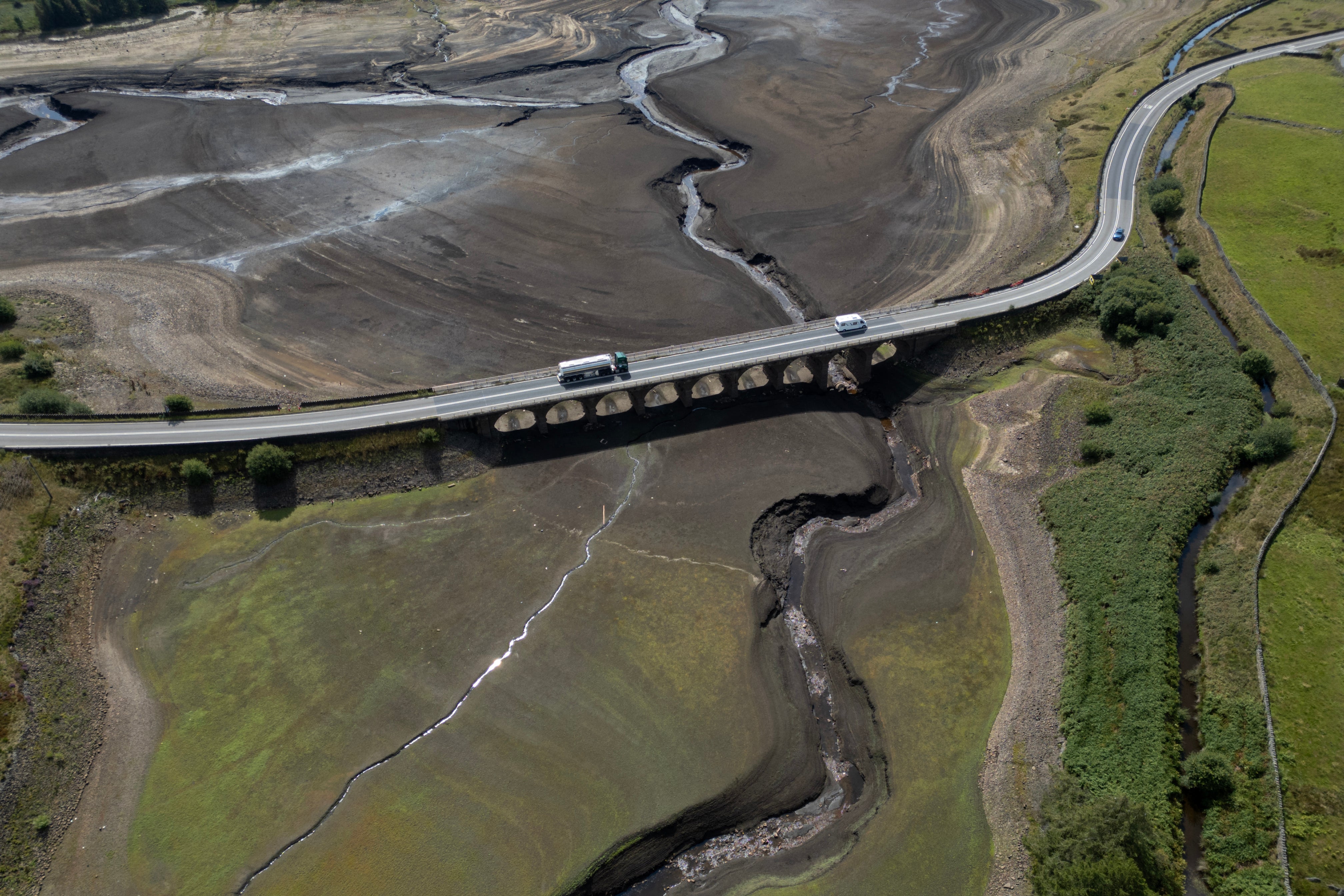 An aerial photograph shows the partially revealed bed of Woodhead Reservoir following a falling water level, near Glossop, northern England