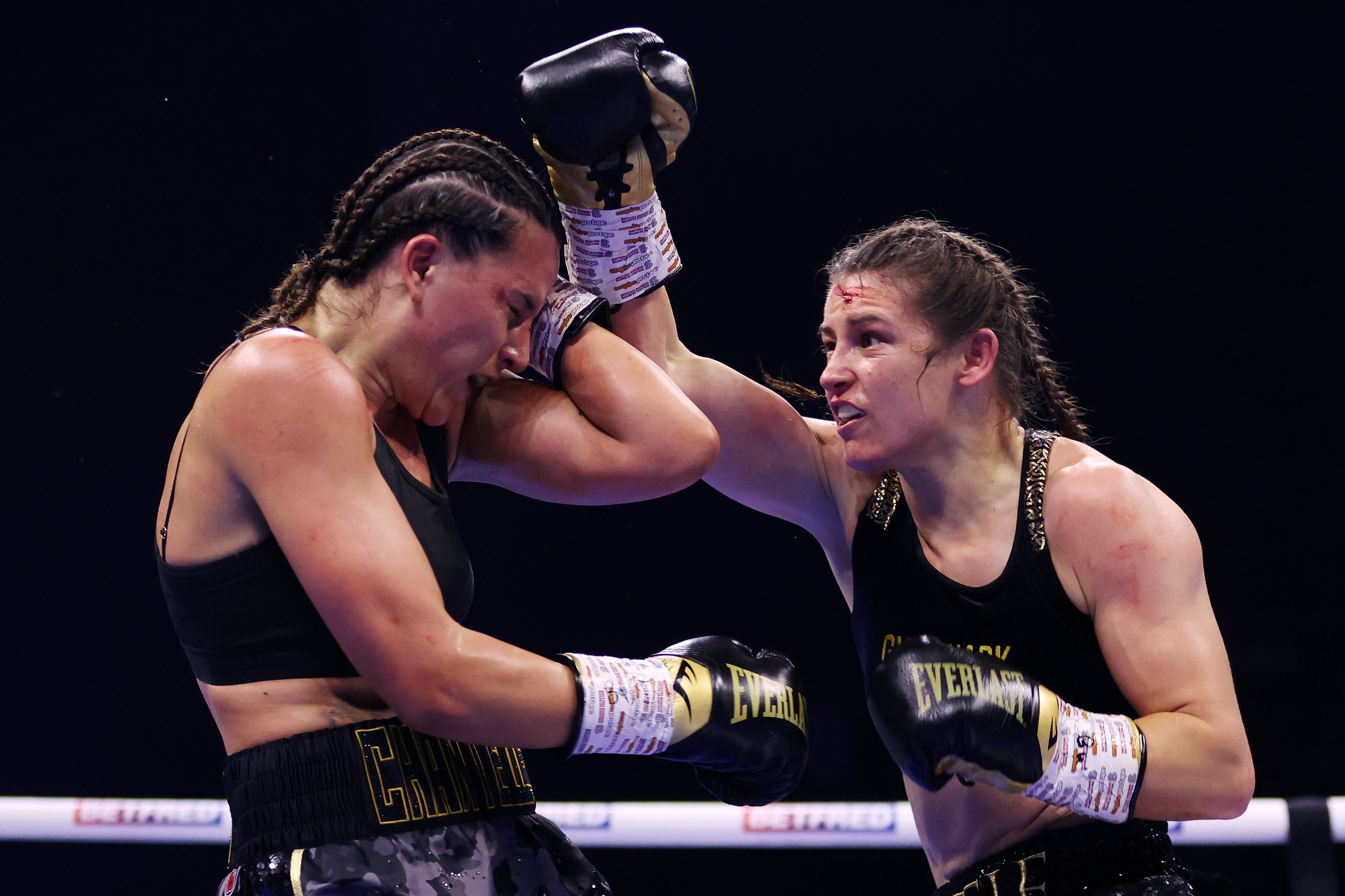 Cameron (left) during her brutal second fight with Katie Taylor in 2023 (Getty)