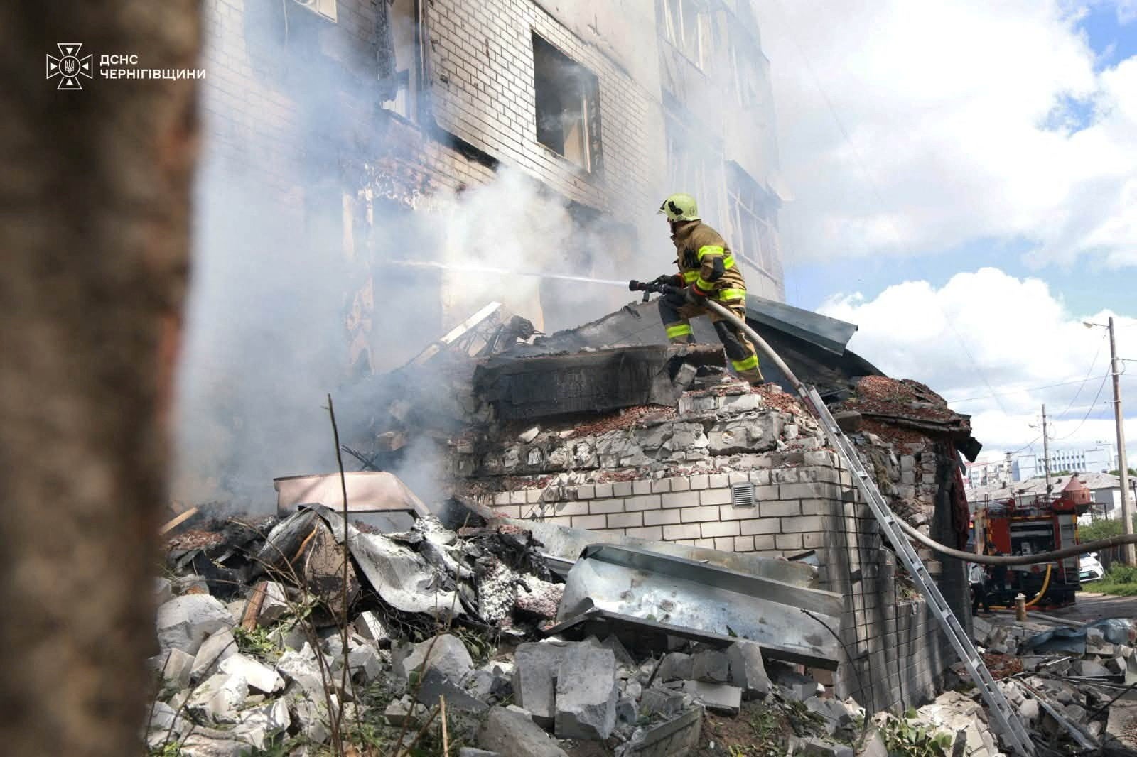 A firefighter works at the site of an apartment building hit by a Russian drone strike, amid Russia's attack on Ukraine, in Chernihiv