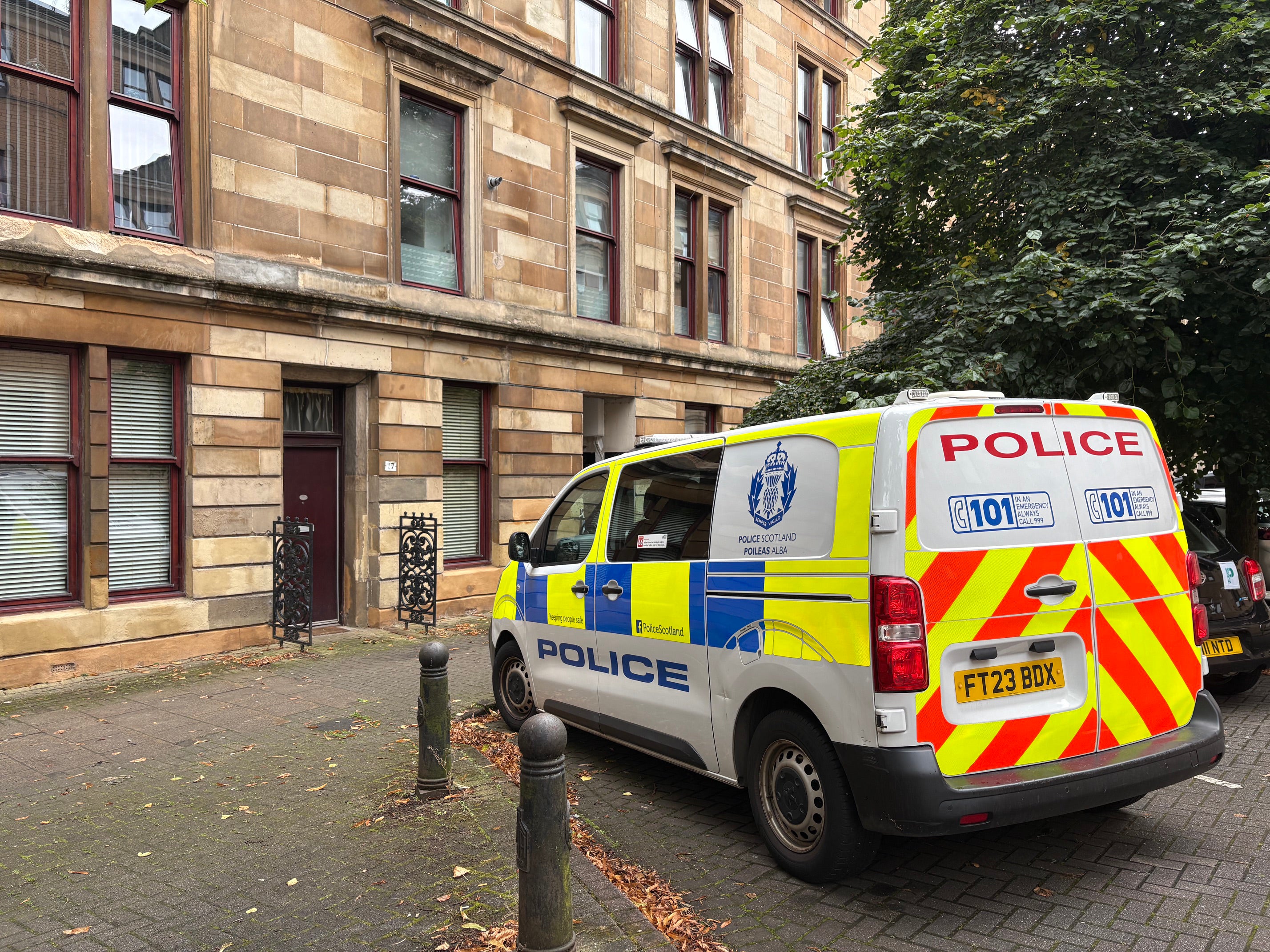 A police van on Chancellor Street in the Partick area of Glasgow, as the police have launched a double murder investigation after the bodies of two men were found in a flat in Glasgow