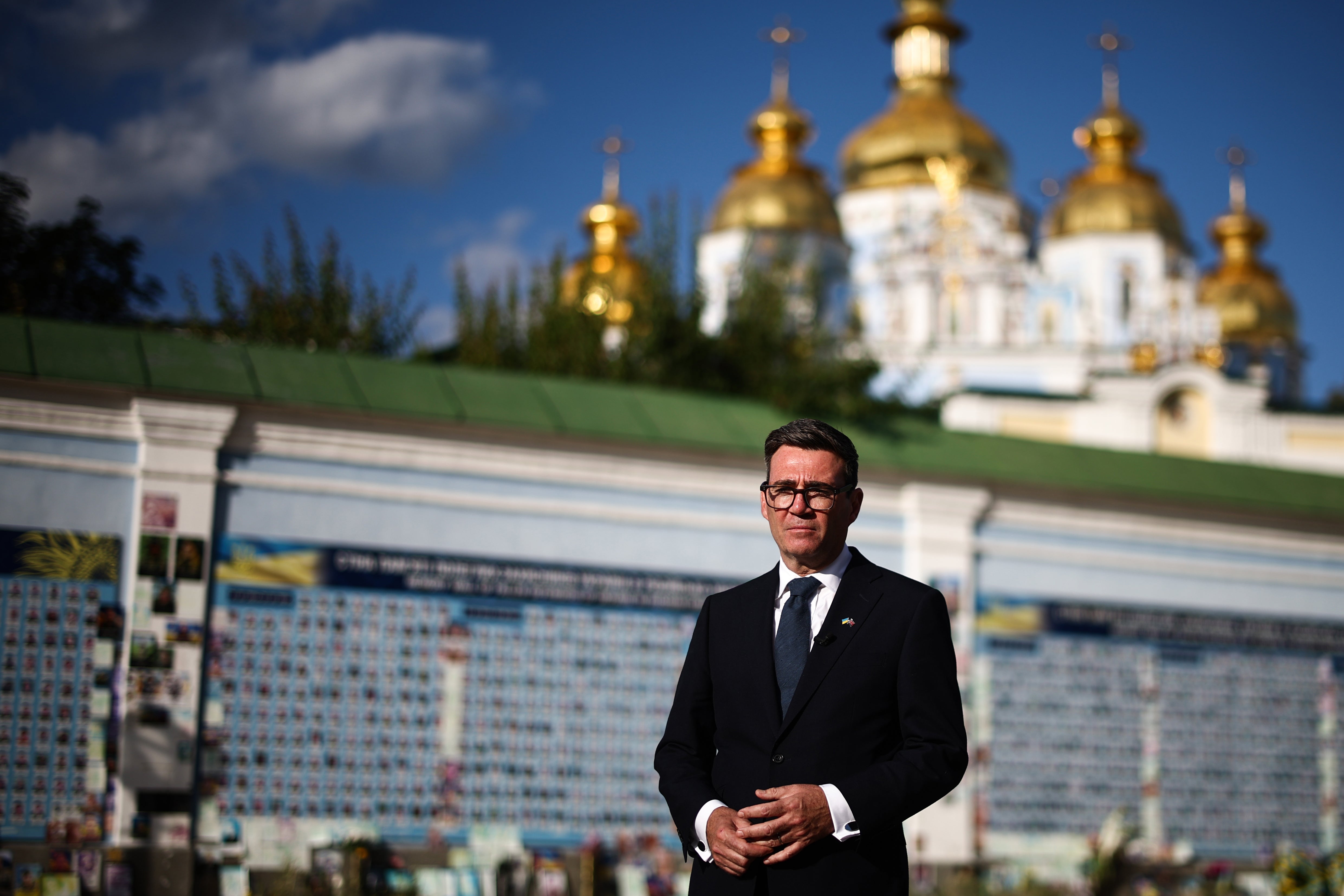 Prime Minister Andy Burnham poses in front the Wall of Remembrance at Mykhailivska Square