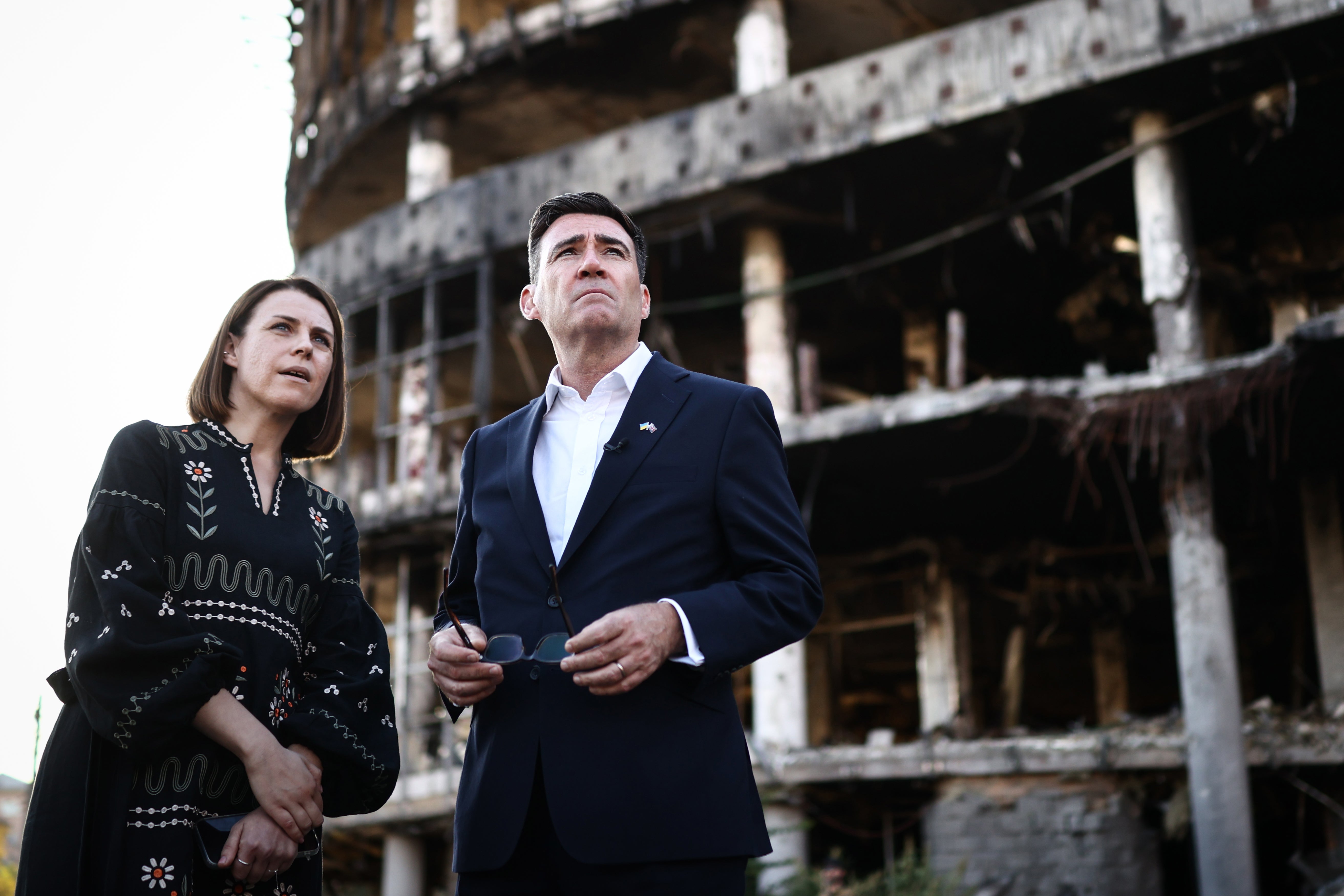 Andy Burnham reacts as he is shown the damage of the buildings and site of a strike at Lukanivska market (Getty)