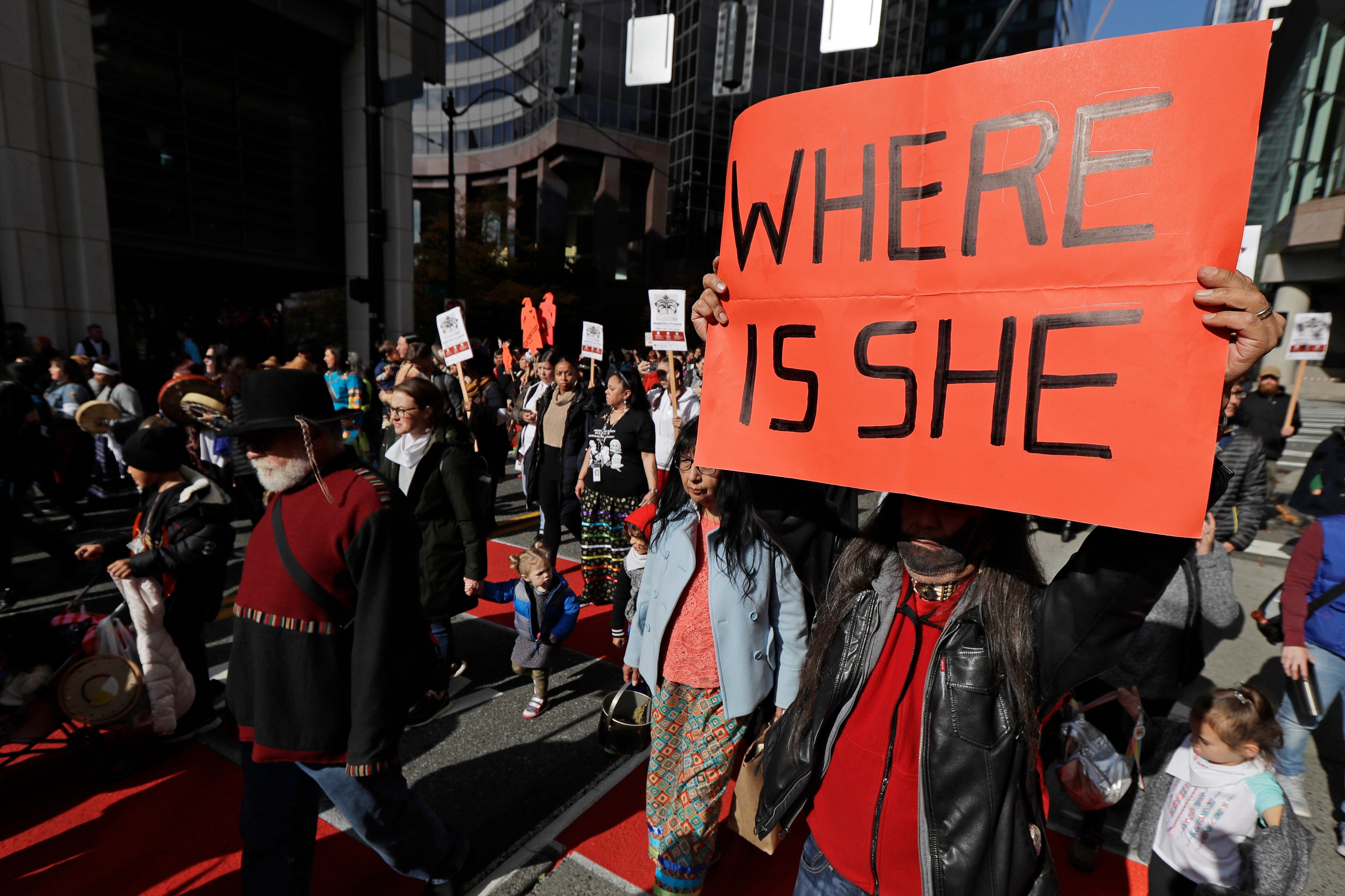 Dennis Willard, of Bellevue, Wash., carries a sign that reads 
