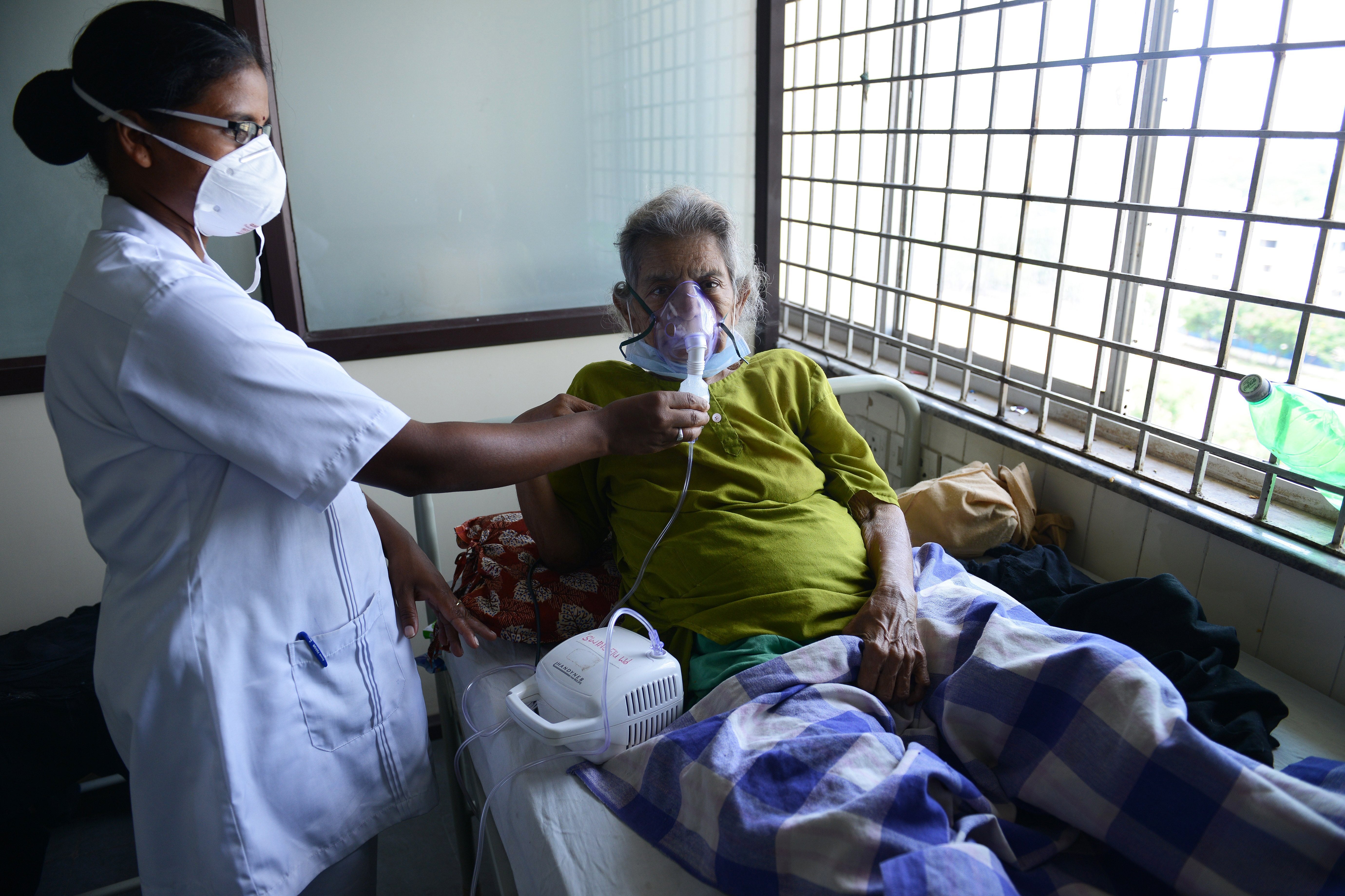 An Indian health professional tends to a patient in a swine flu ward at the Gandhi Hospital in Hyderabad on 24 September 2015