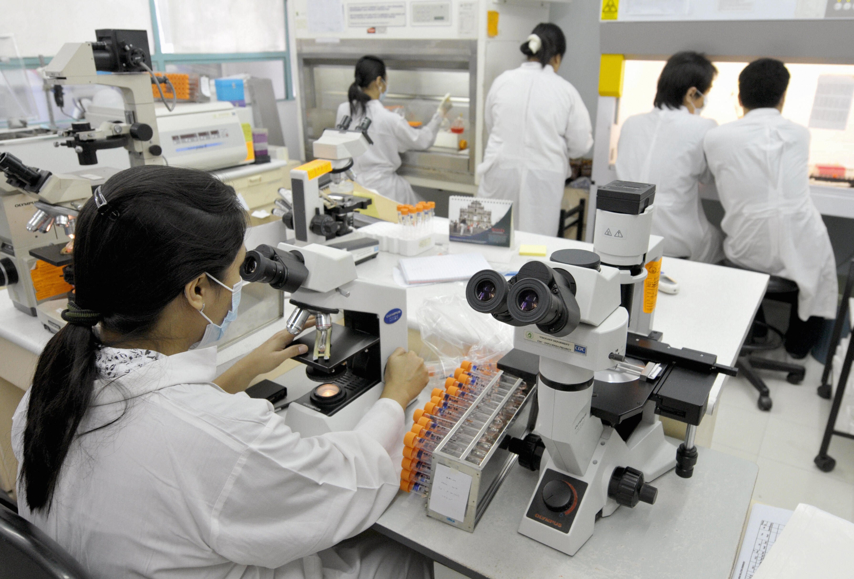 Medical technicians at the Research Institute for Tropical Medicine perform tests for viruses including dengue fever and swine flu in Manila