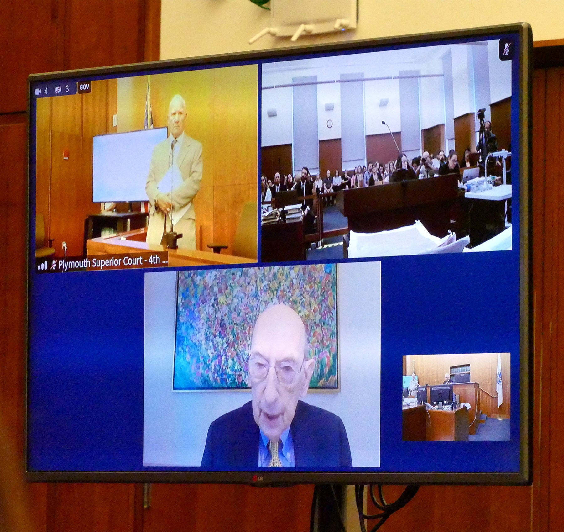 A screen shows defense attorney Kevin Reddington as he interviews witness Phillip Resnick, on remote feed, from Cleveland (Reuters)