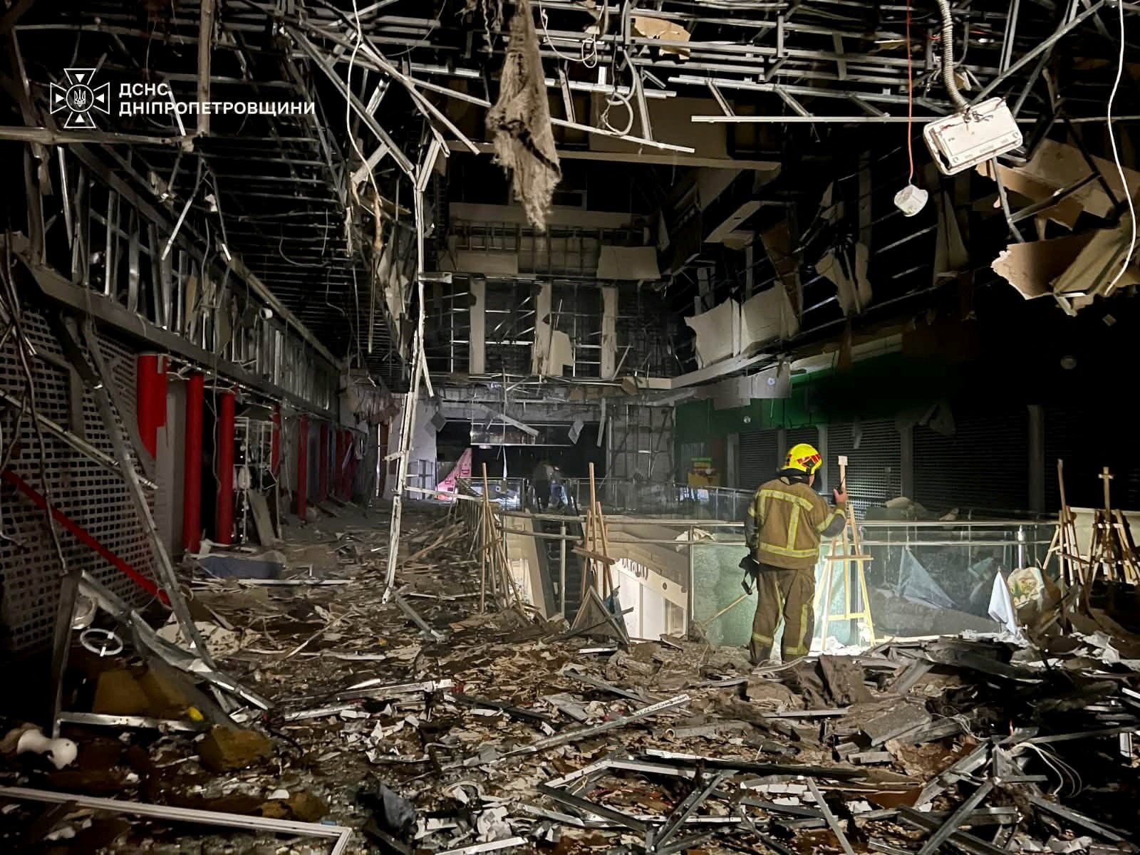 A rescuer works at a site of a shopping mall hit by a Russian drone attack, amid Russia's attack on Ukraine, in Dnipro, Ukraine