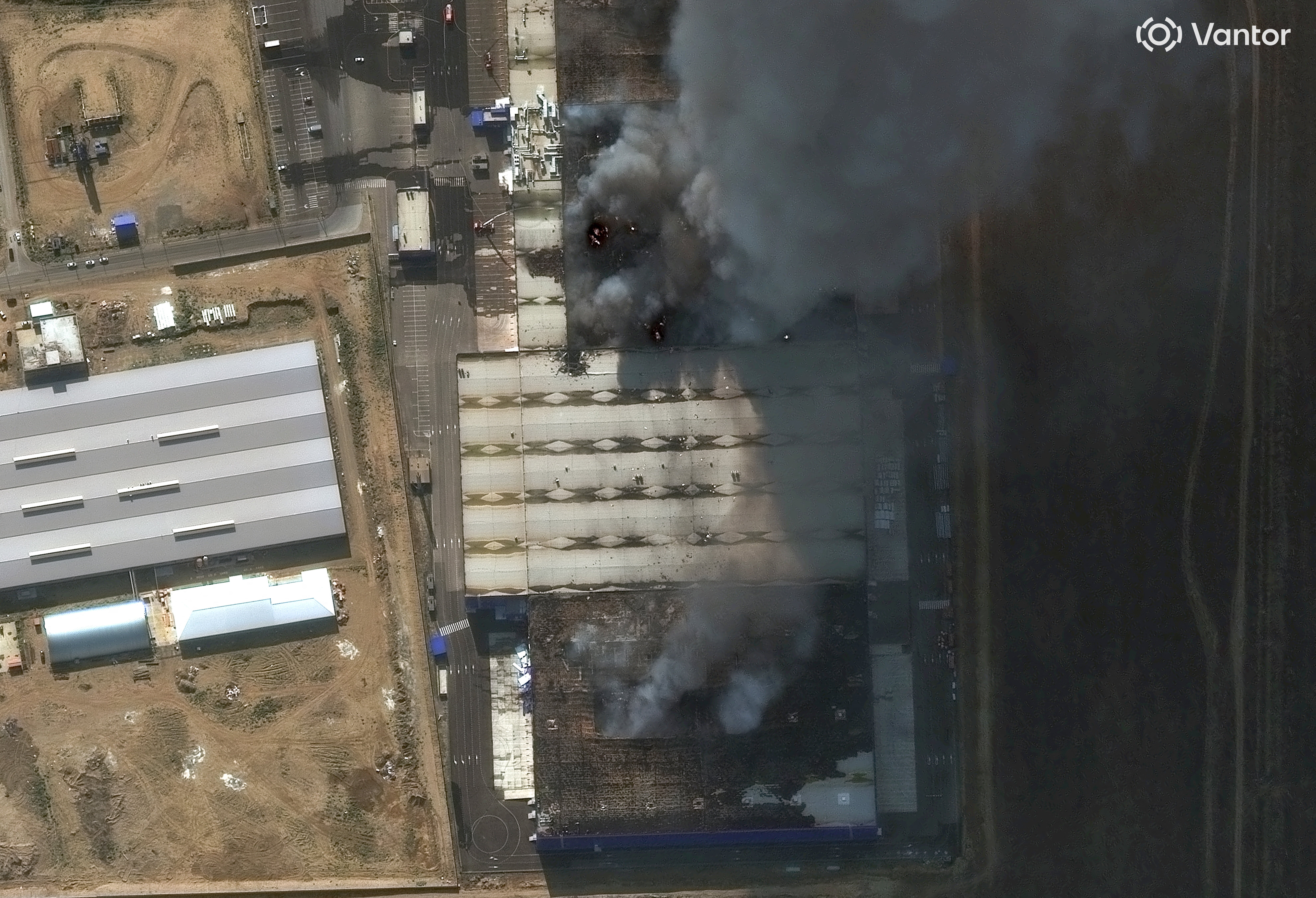A satellite image shows smoke rising from an Ozon warehouse