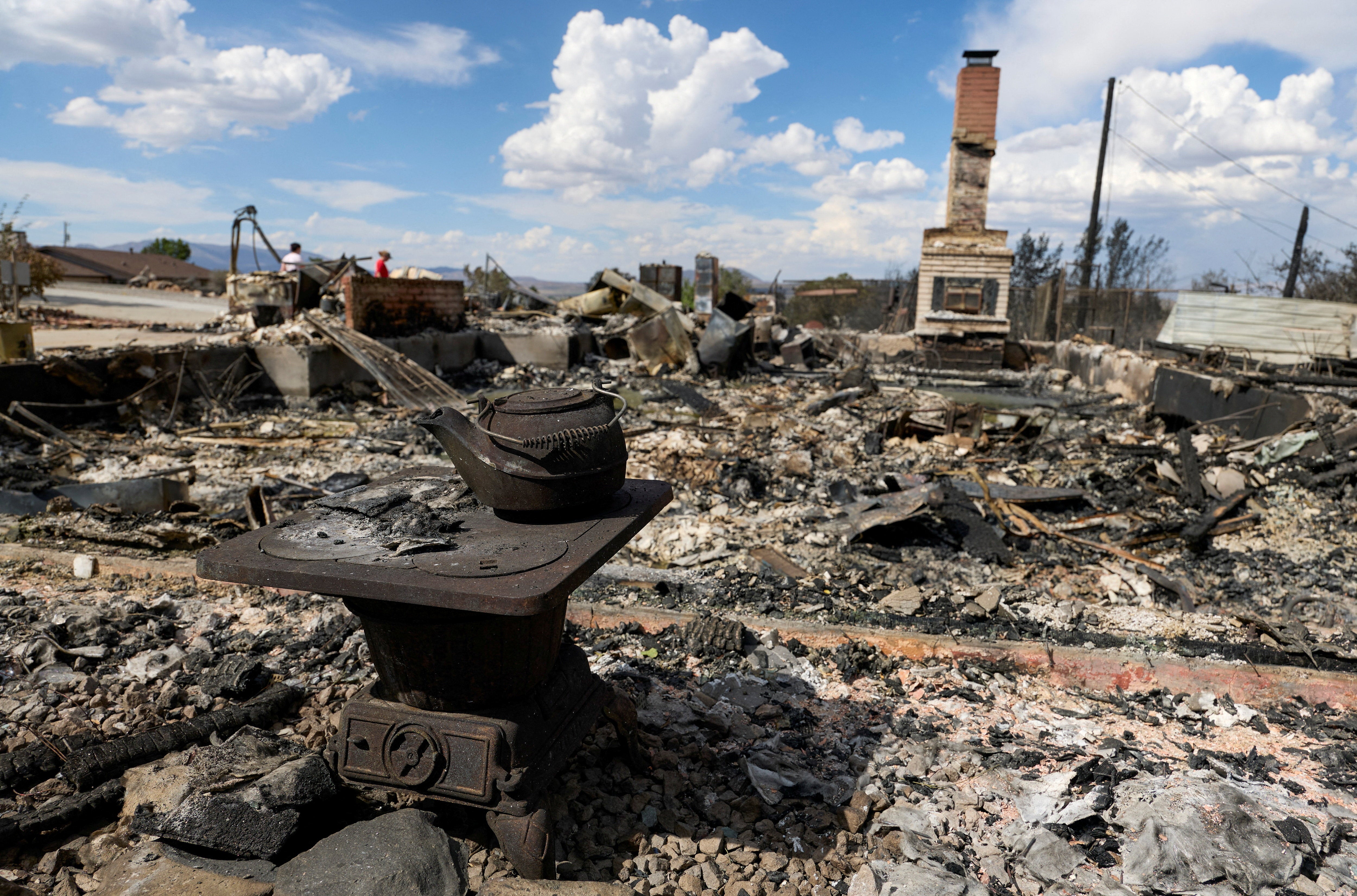 An old stove and teakettle next to a home that burned down during the Hawk Fire in Reno
