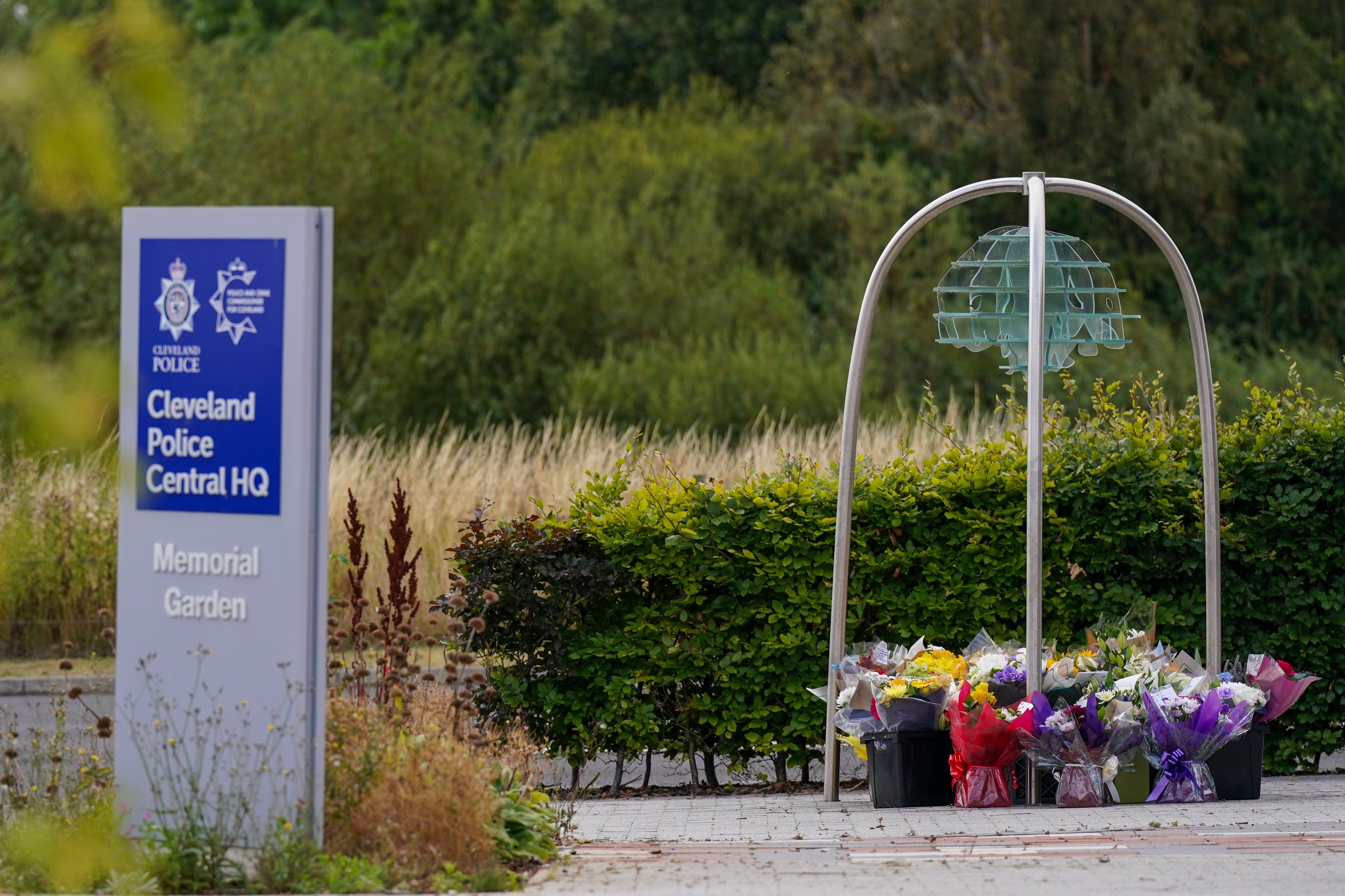 Floral tributes are left at Cleveland Police Central Headquarters Memorial Garden in Hemlington (Getty)