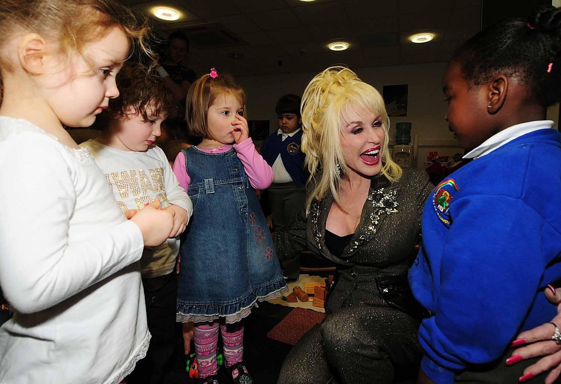 Dolly Parton meeting children at an event for her Imagination Library, which has given more than 270 million books to children around the world