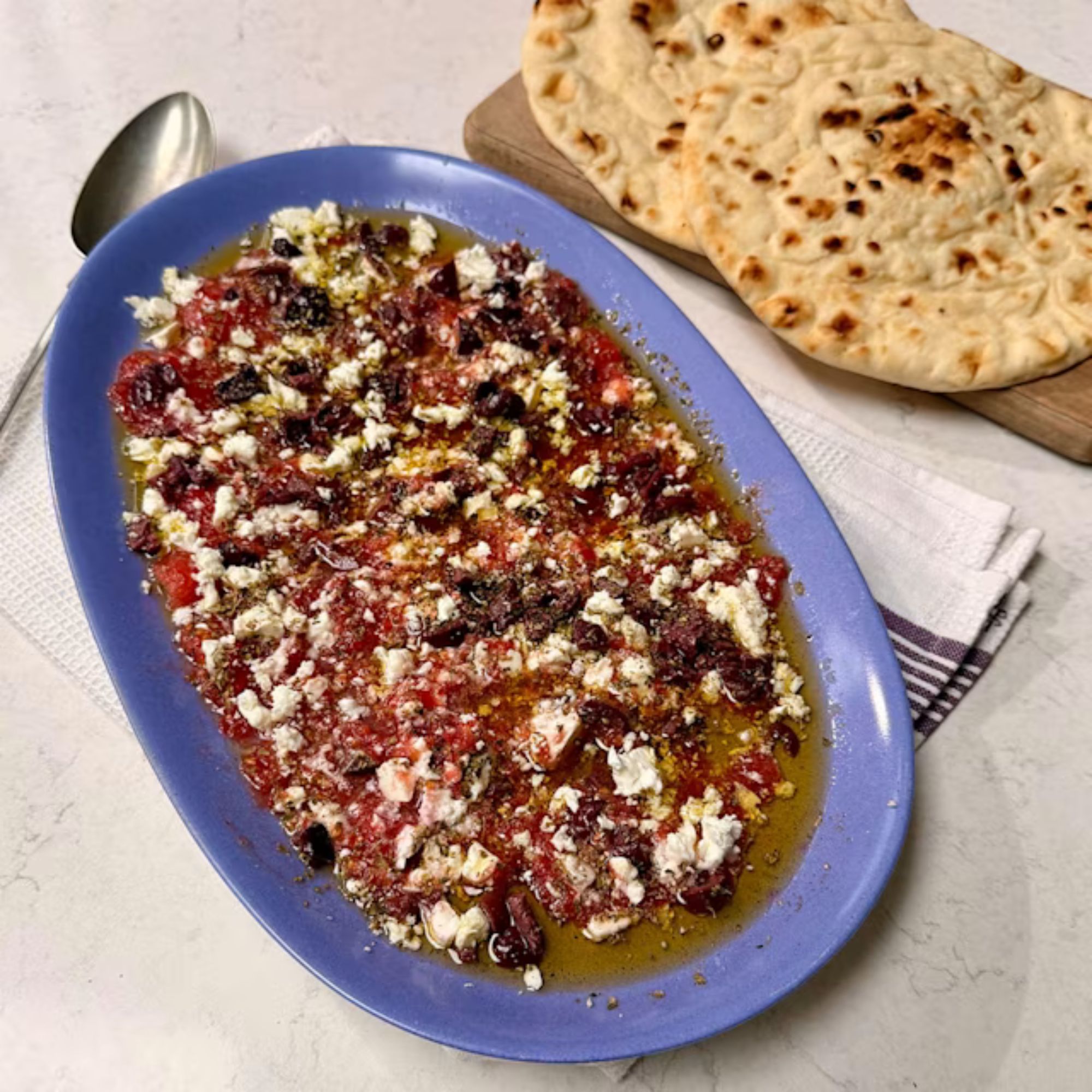 Feta, tomato and olive oil turn a few simple ingredients into something worth tearing bread over