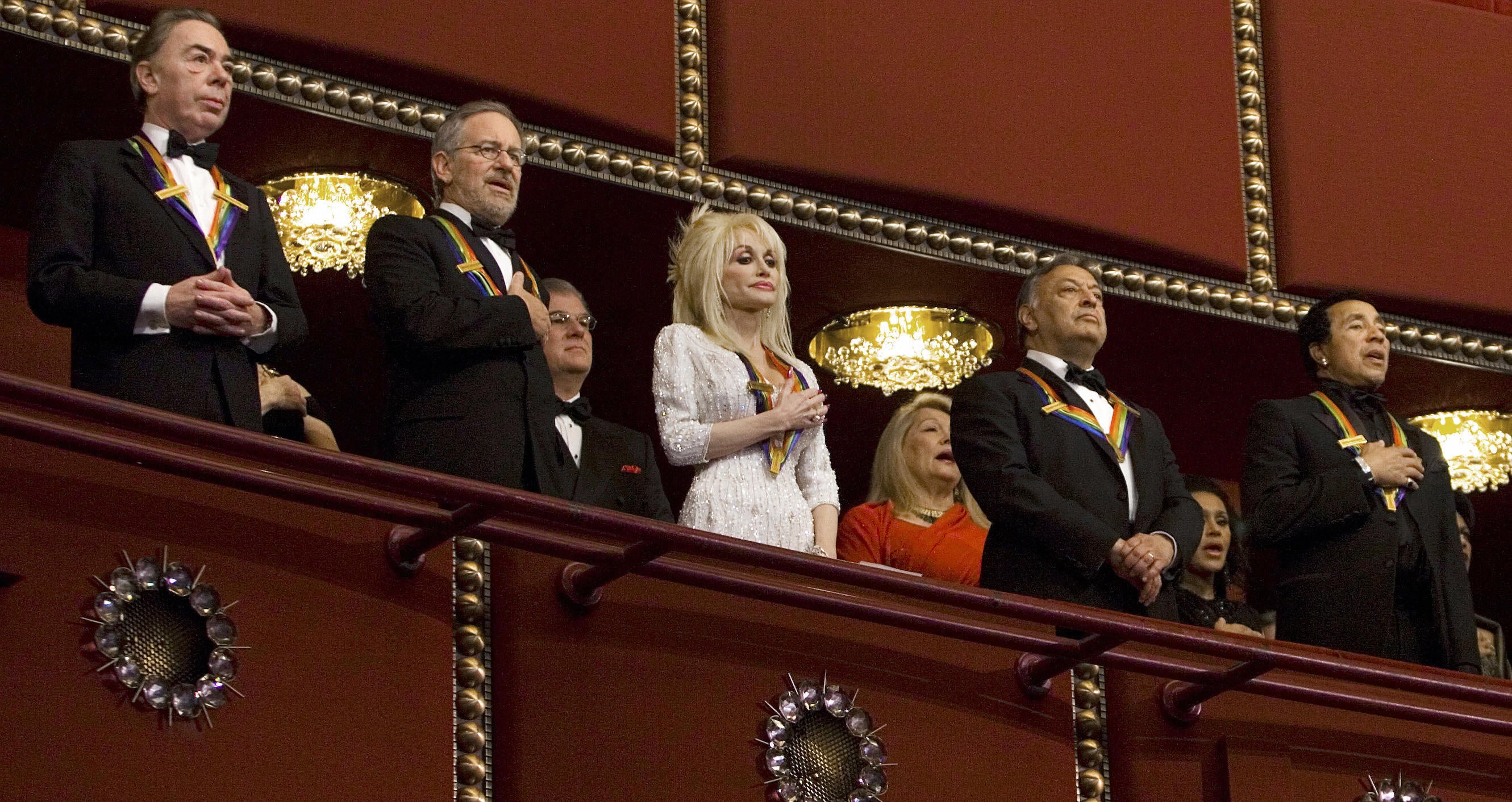 Theatre producer Andrew Lloyd Webber (L), film director Steven Spielberg (2L), singer Dolly Parton (C), conductor Zubin Metha (2nd R) and singer Smokey Robinson (R) stand for the national anthem during the 2006 Kennedy Center Honors taping