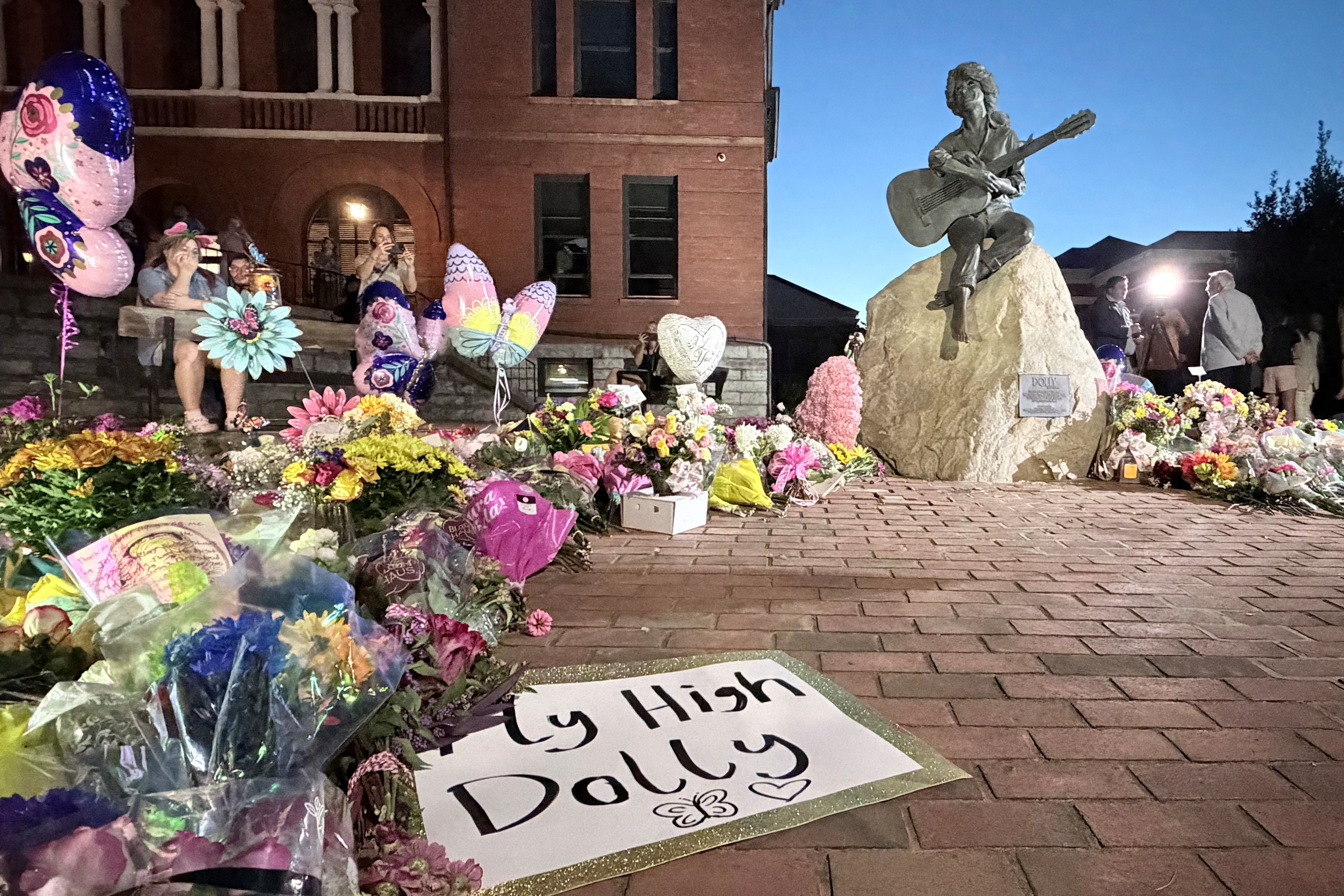 Mourners pay their respects to Dolly Parton after the announcement of her passing, at the Dolly Parton Statue in downtown Sevierville, Tennessee