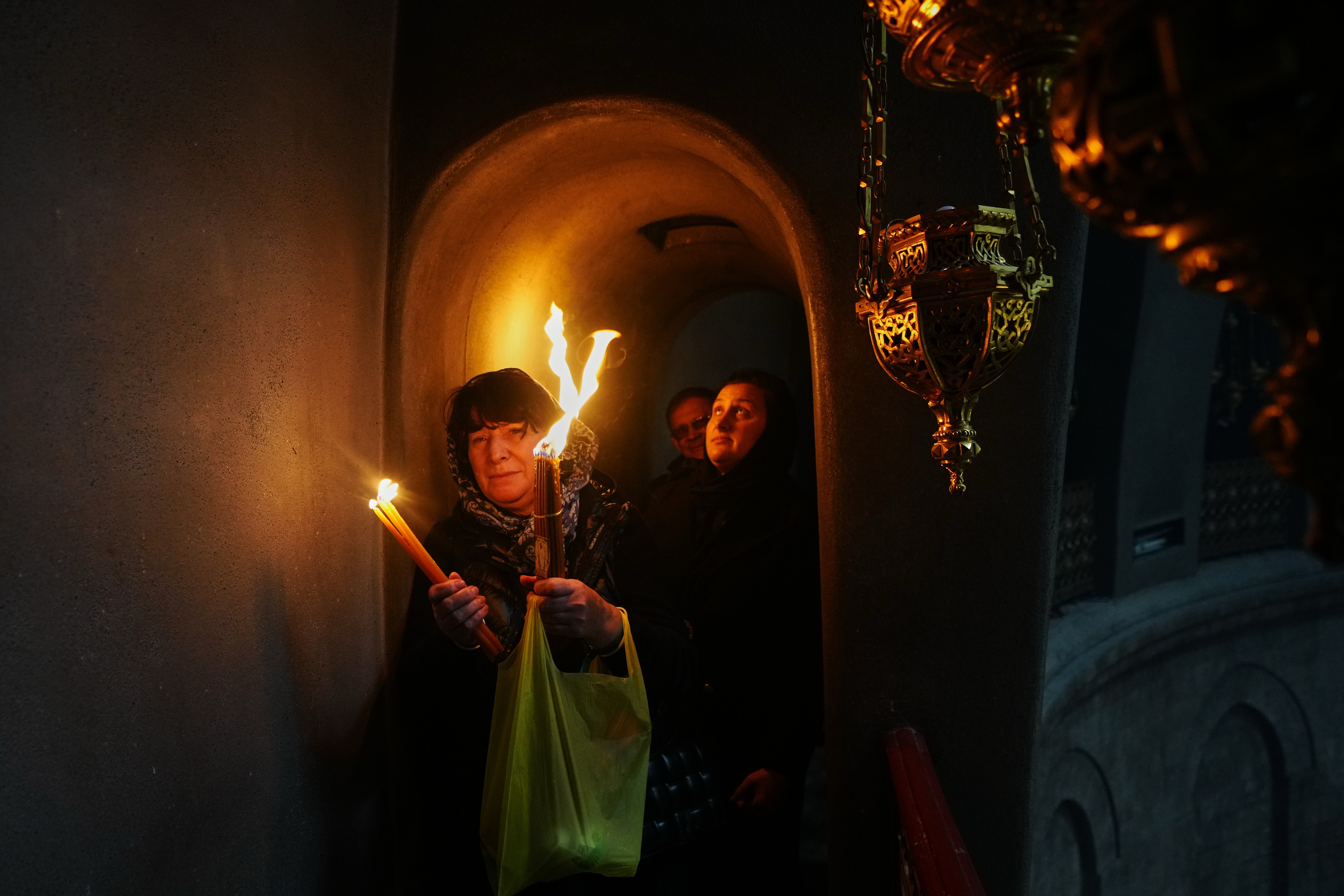 Christian Orthodox pilgrims hold up candles during the Holy Fire ceremony at the Church of the Holy Sepulcher