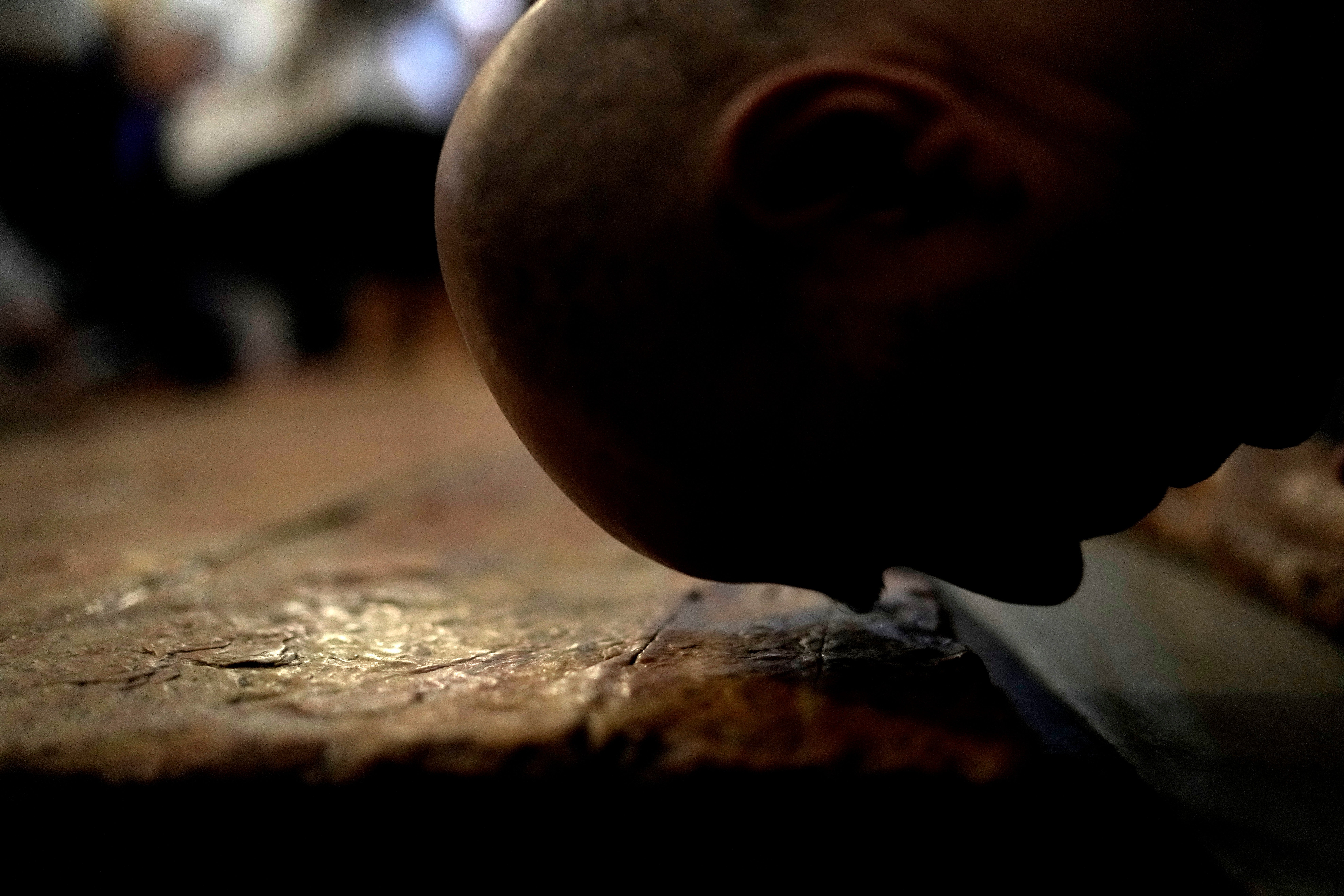 A Christian worshipper kisses the Stone of Unction, the stone slab traditionally claimed as the stone where Jesus' body was prepared for burial