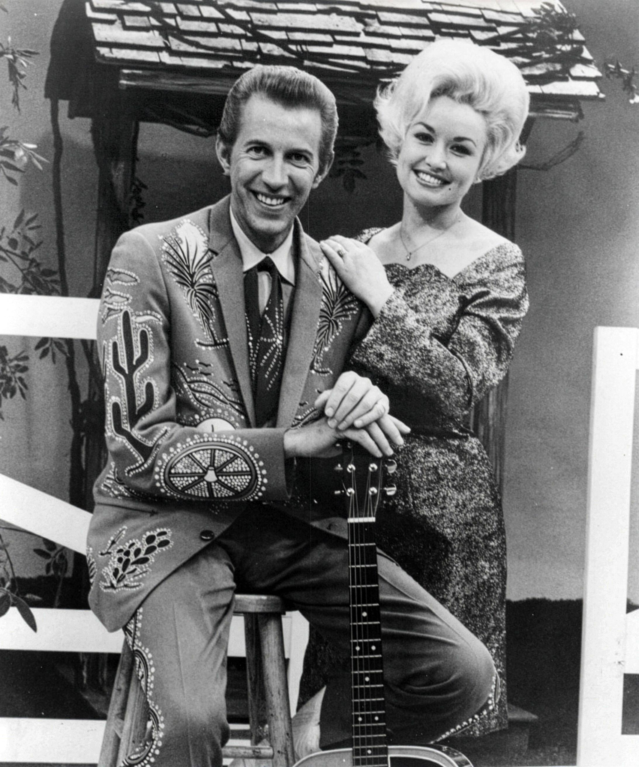 Parton provided a traditionally hyper-feminine counterpoint to his rhinestone cowboy look, favouring figure-hugging dresses, high heels and enormous blonde hair (Alamy/PA)