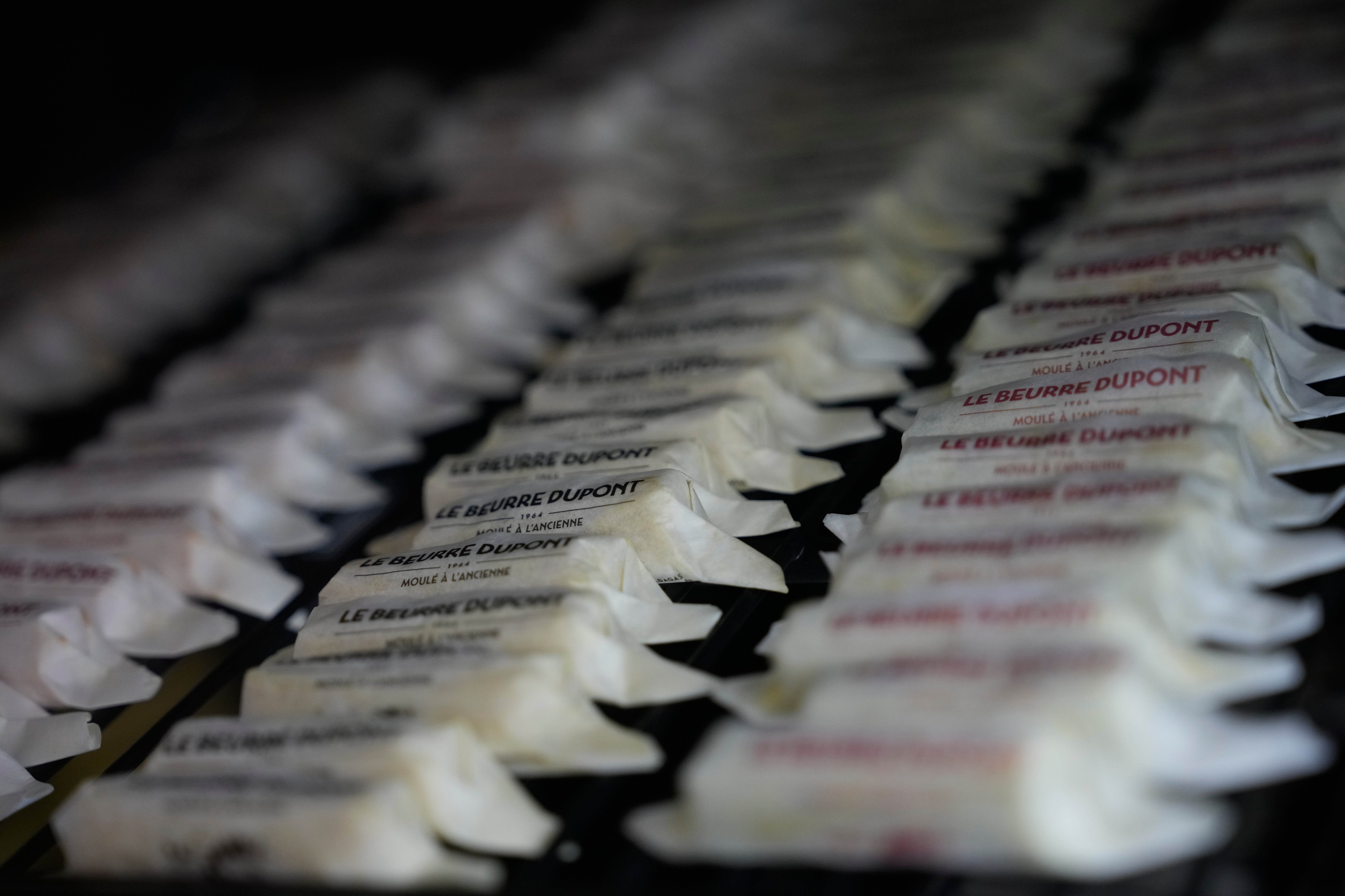 Packs of butter with different flavors are displayed in a refrigerator at Le Butter Shop