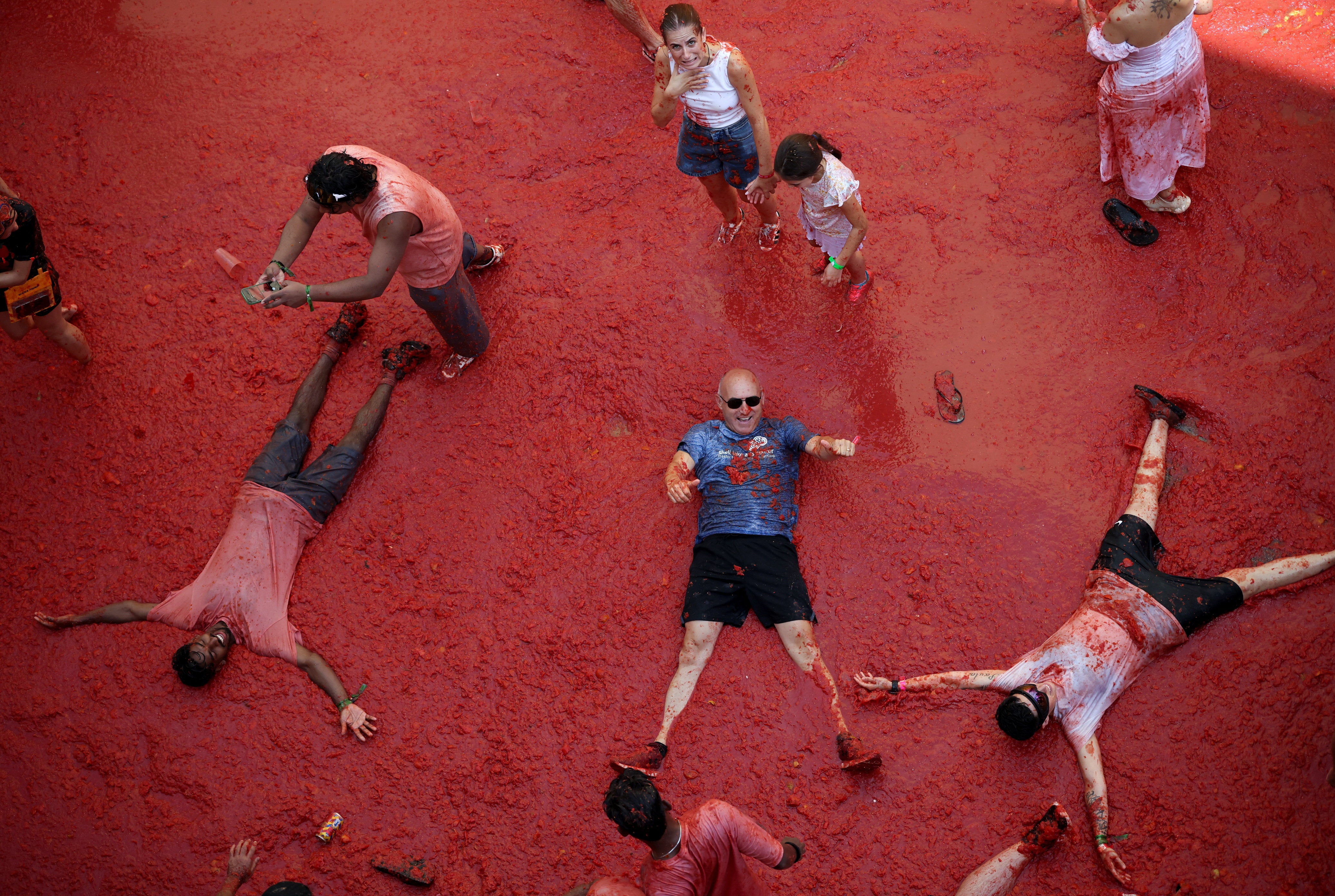 Though stains on clothes can be permanent, the tomatoes' citric acid acts as a cleaning agent, often leaving Buñol’s streets cleaner than before