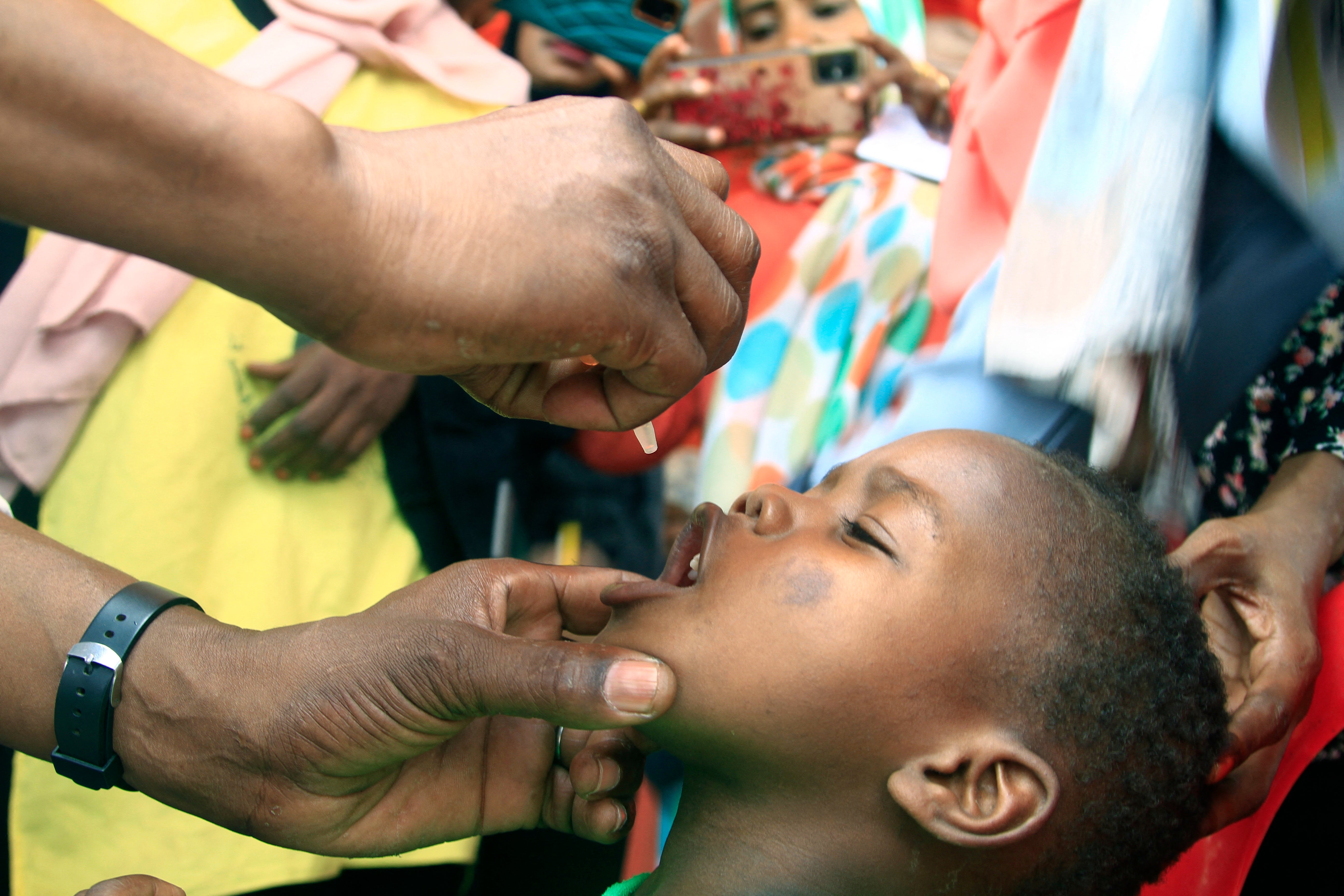 A child is given drops during a UNICEF campaign responding to a polio epidemic in Sudan