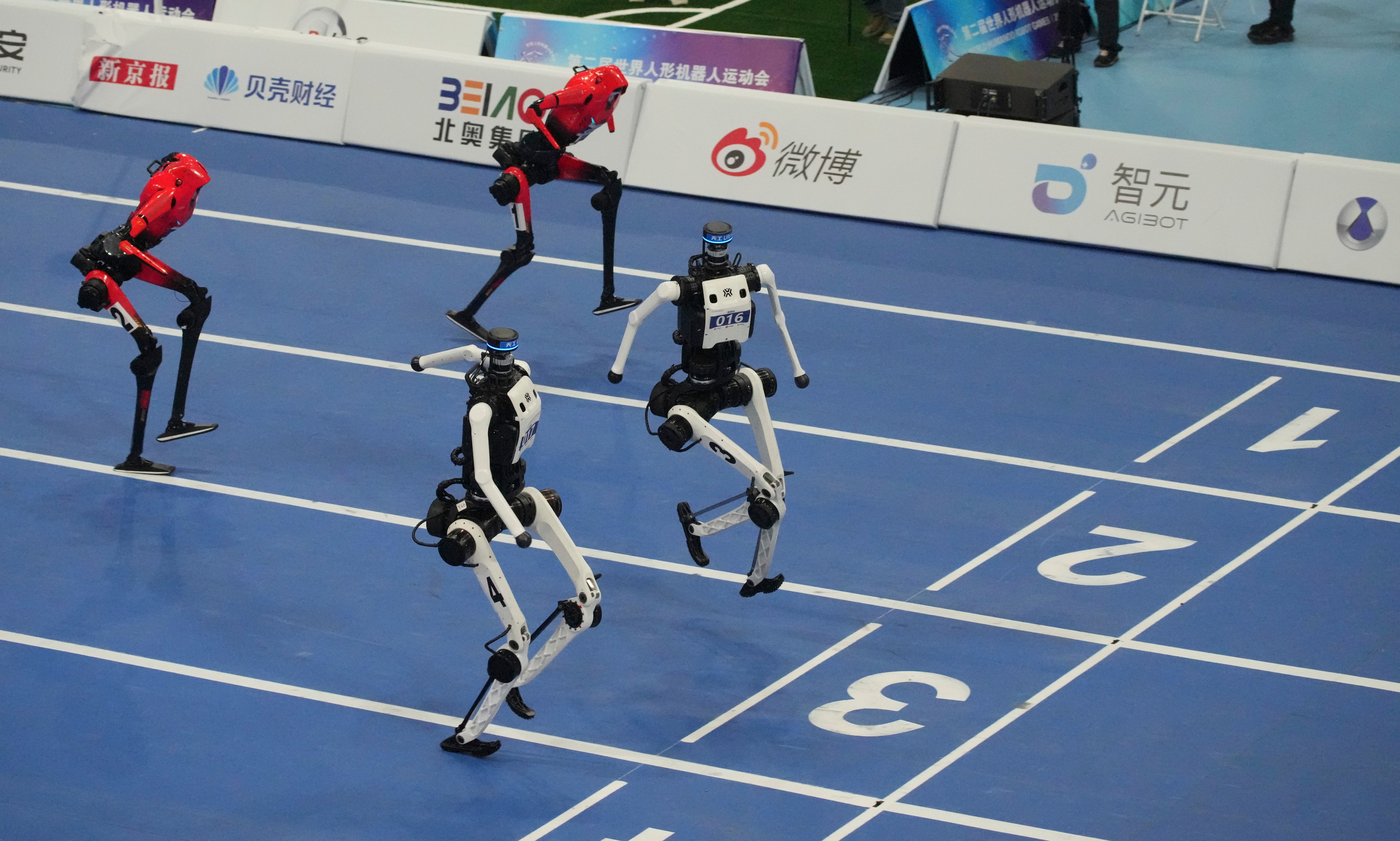 Humanoid robots compete in the 100m final race during the World Humanoid Robot Games in Beijing, Wednesday, Aug. 26, 2026
