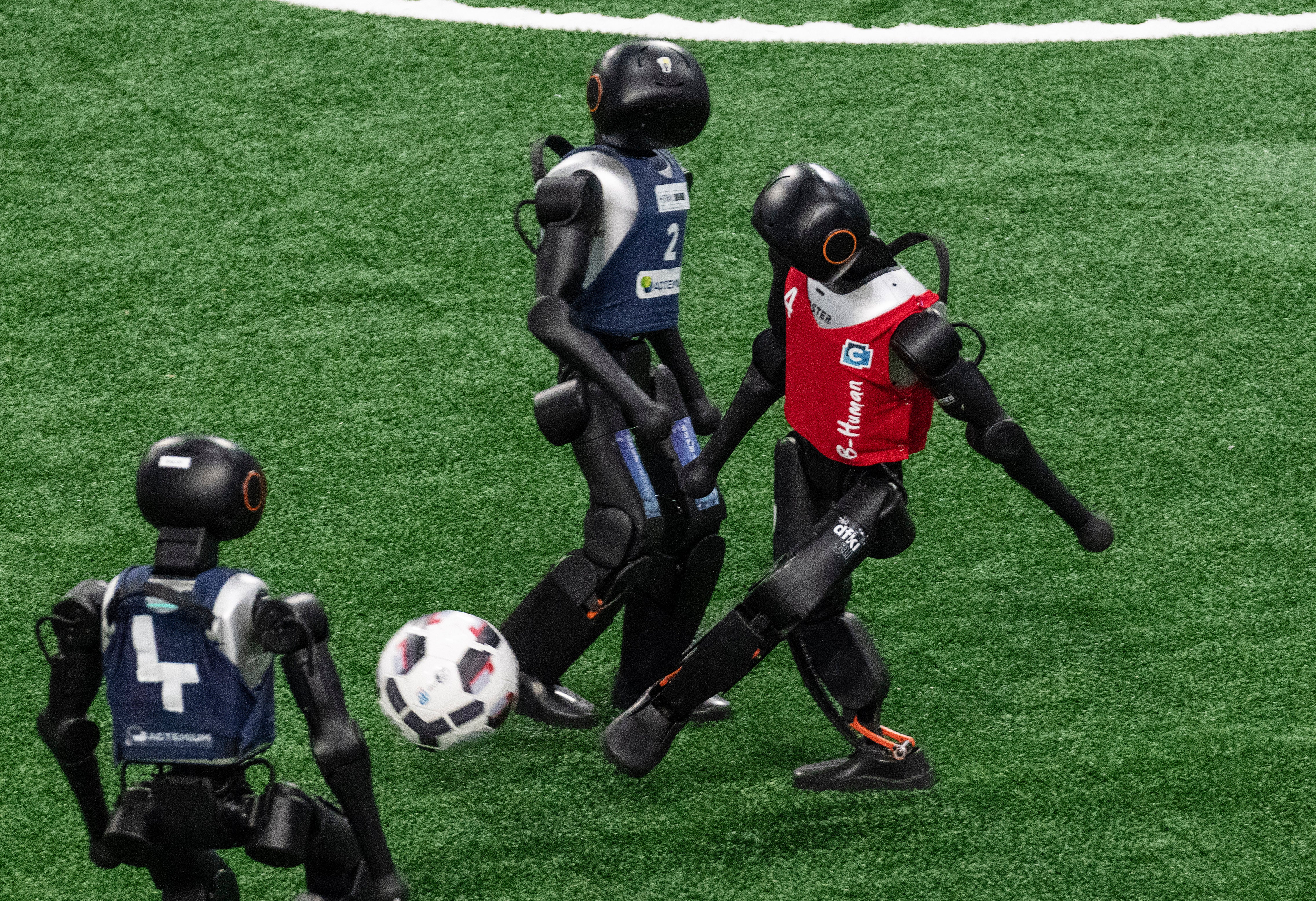 Humanoid robots play football during the final day of the robot games