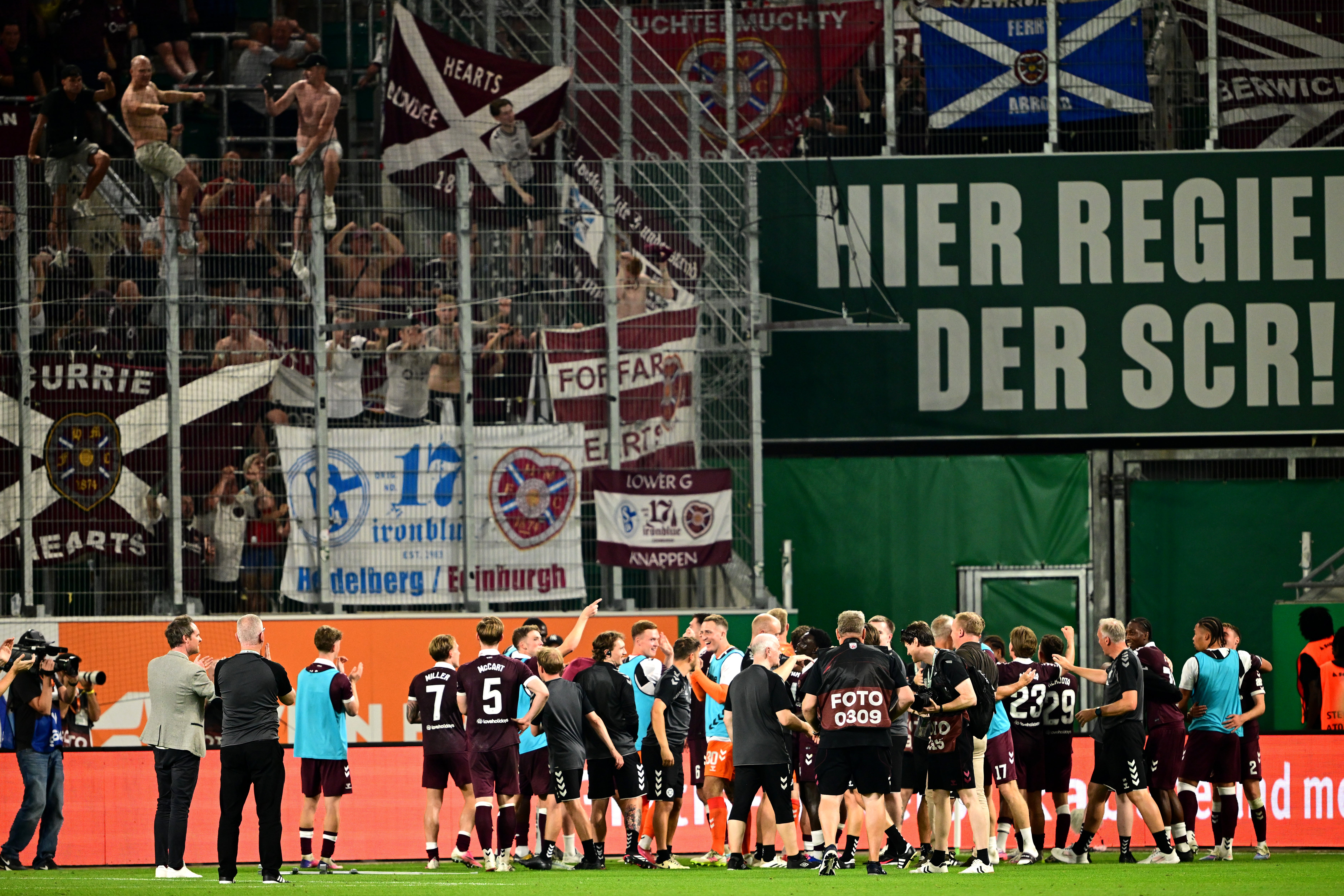 Hearts players celebrate in front of the away fans in Vienna