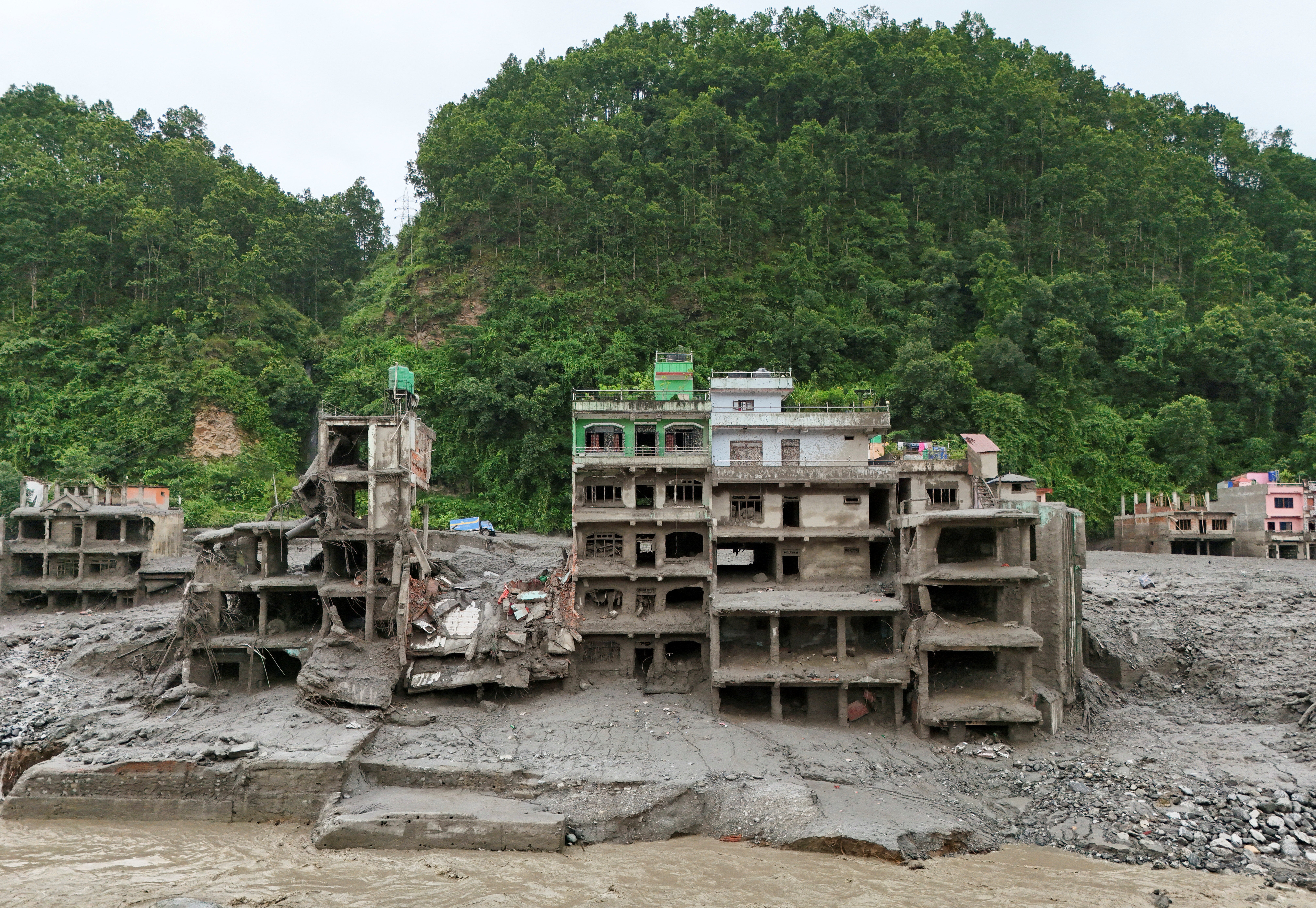 A drone view shows mud covering properties following a flash flood in Trishuli (Reuters)