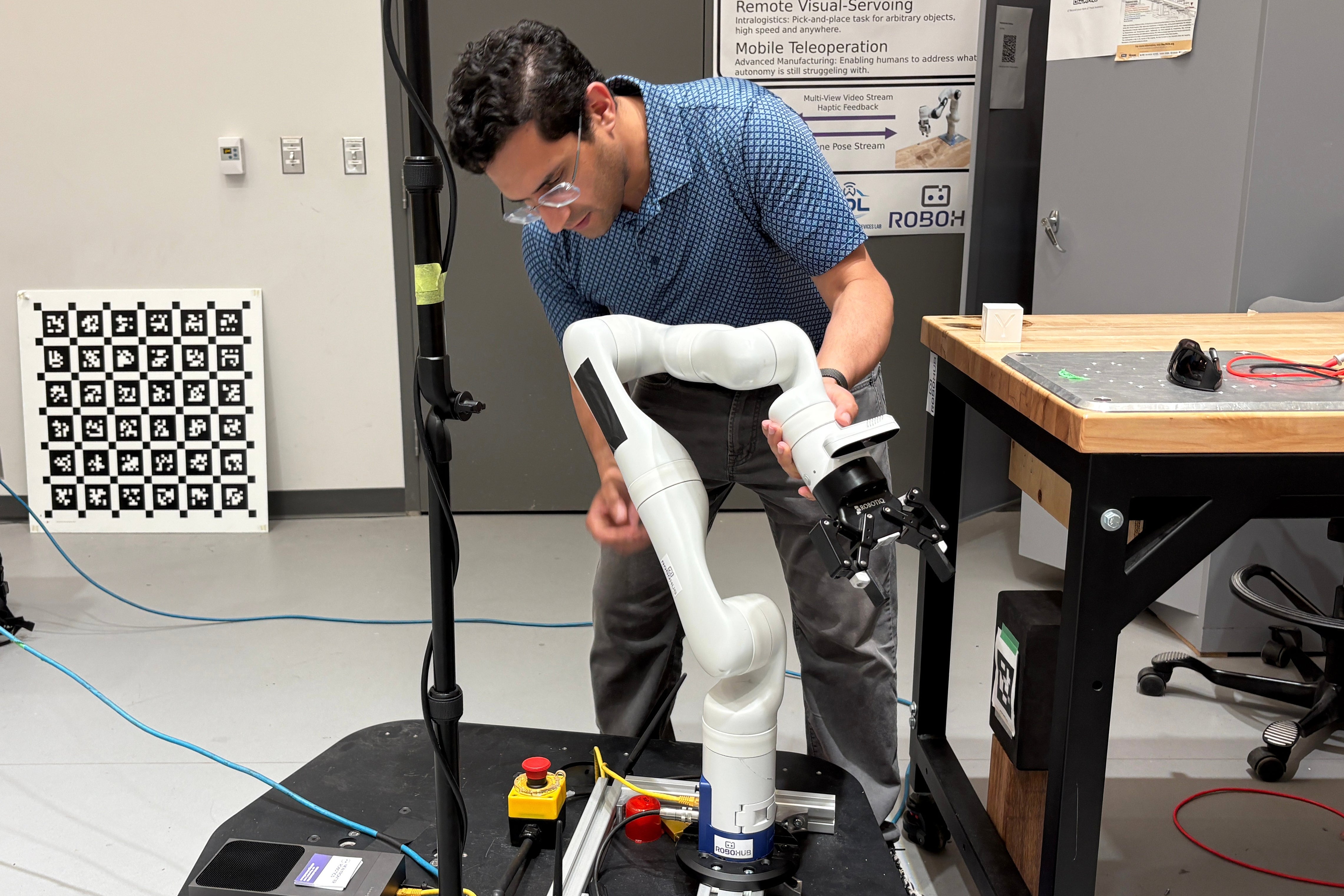 Nikhil Malhotra, co-founder of New Frontier Robotics, demonstrates his mobile manipulator robot arm in a lab at the University of Waterloo