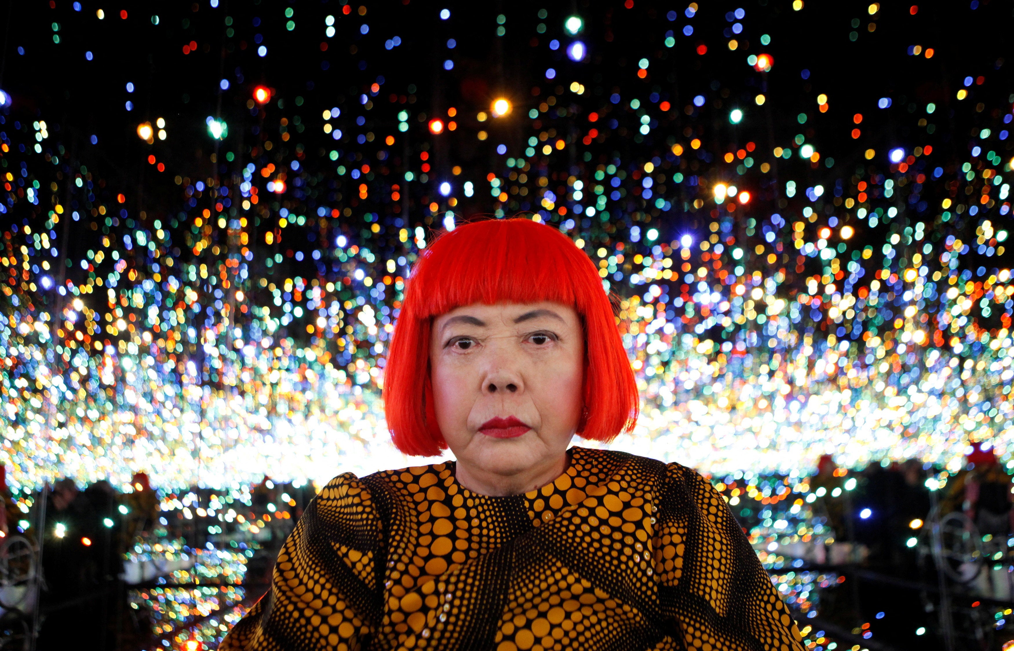 Yayoi Kusama poses for a photograph inside her Infinity Mirrored Room installation titled ‘The Souls of Millions of Light Years Away.’ (Reuters)