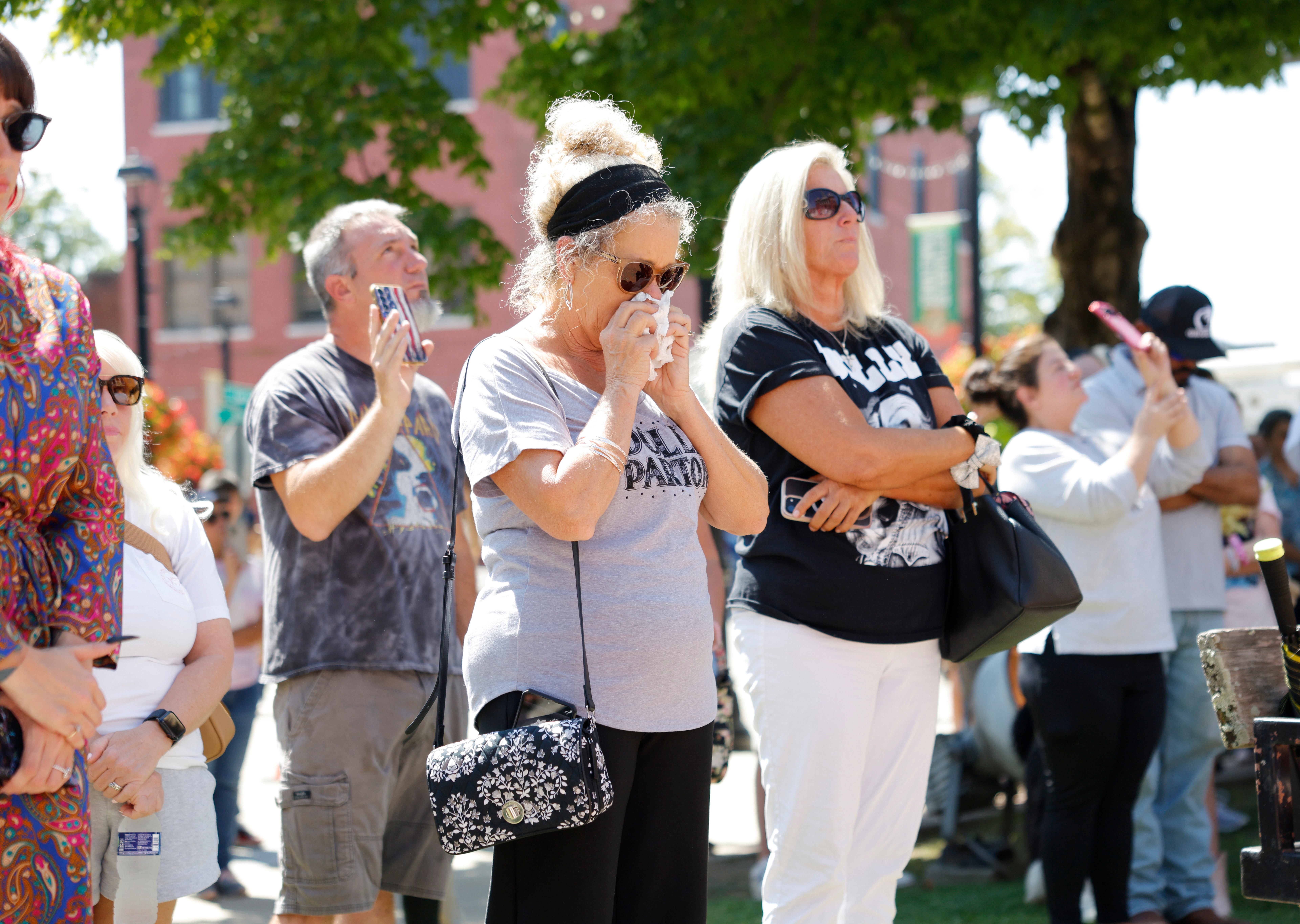 Fans attend a moment of silence at The Dolly Parton Statue on the front lawn of the Sevier County Courthouse