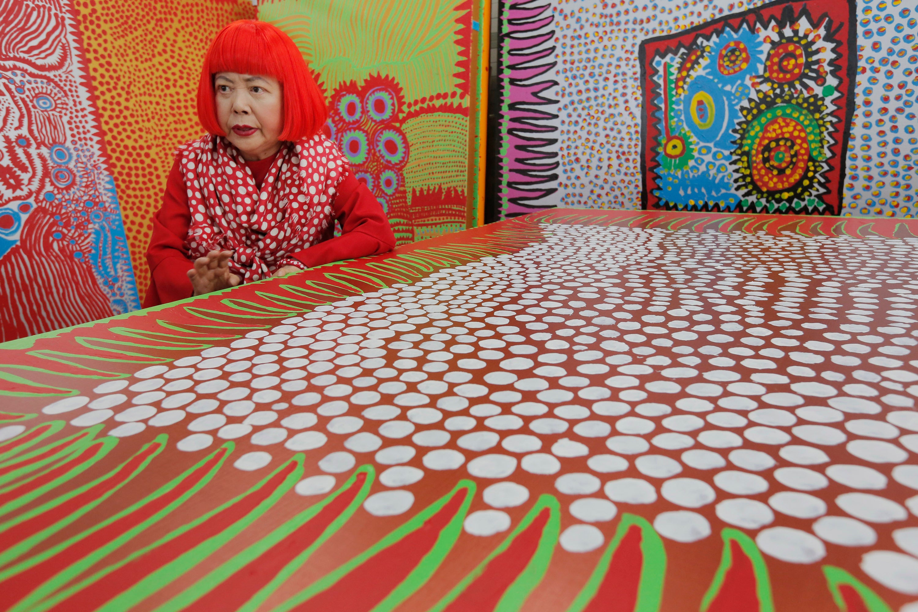 Yayoi Kusama speaks during an interview at her studio, filled with wall-sized paintings throbbing with her repetitive dots, in Tokyo. (Copyright 2026 The Associated Press. All rights reserved.)