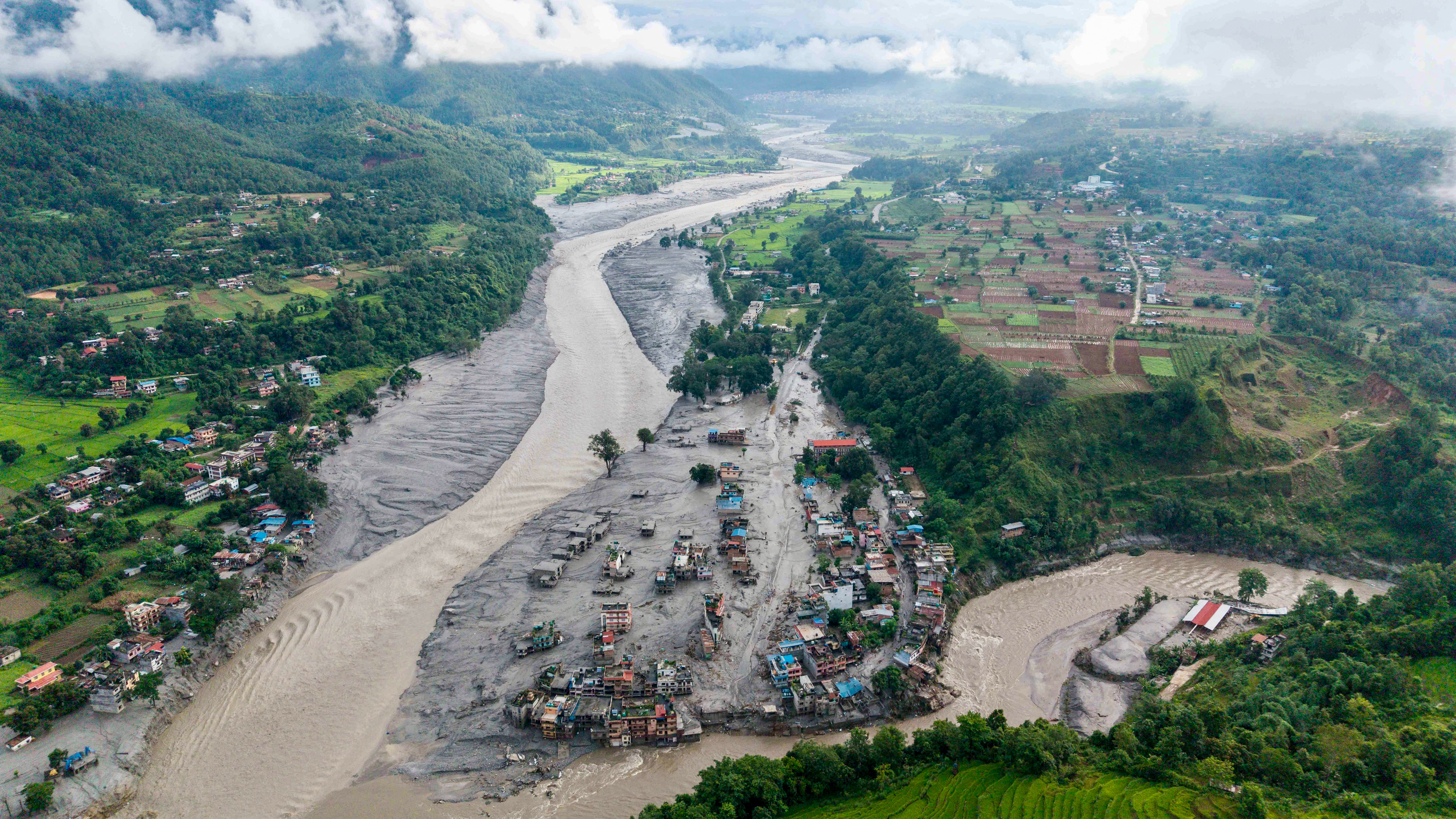 An aerial view shows houses lying deluged in sludge after flash floods at Devighat, Bidur Municipality, along the confluence of the Trishuli and Tadi rivers in Nepal's Nuwakot district on August 27, 2026
