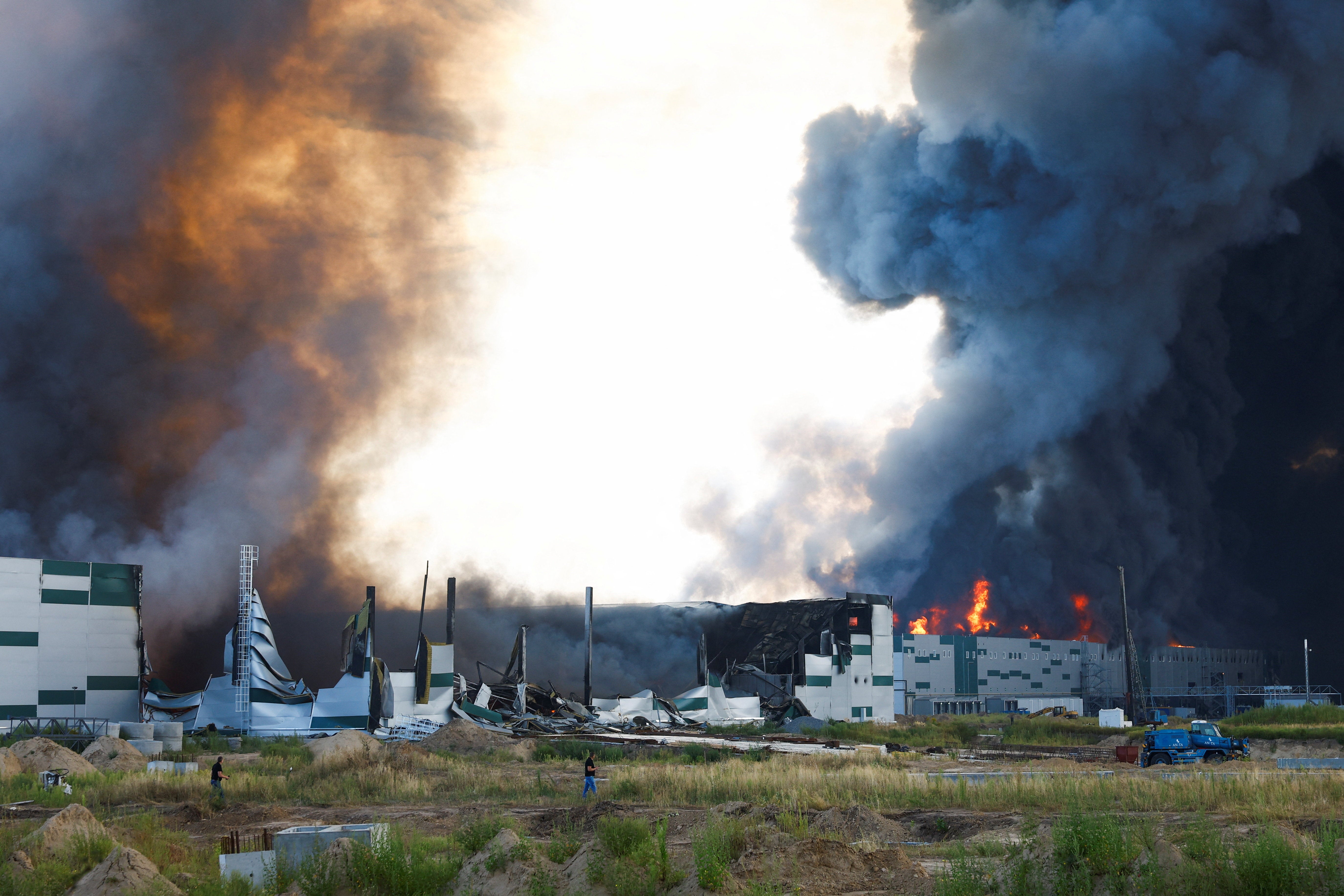 Smoke rises over a warehouse, which was hit by a Russian drone strike, amid Russia's attack on Ukraine, in Kyiv region, Ukraine, August 27, 2026.