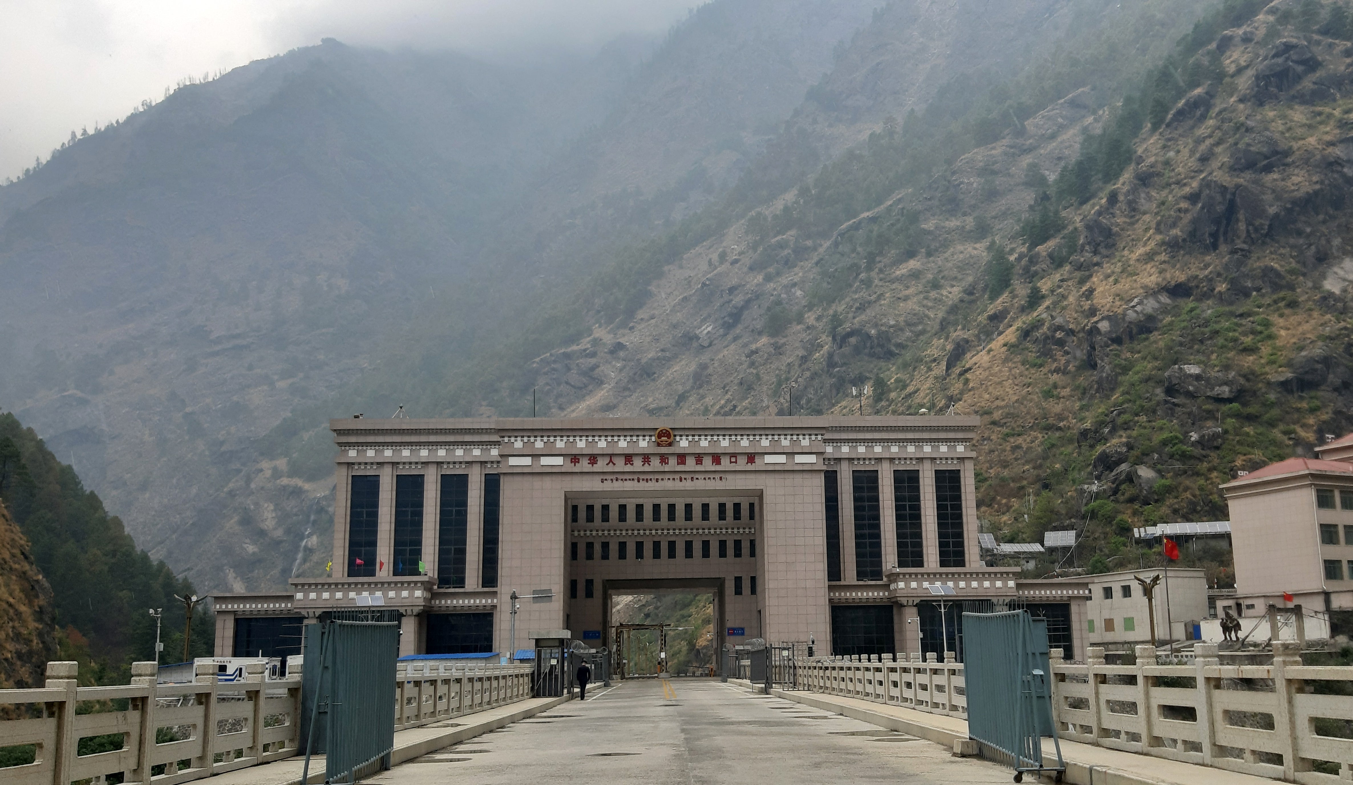 This general view, taken on April 30, 2023, shows the under-construction Gyirong Port Building in the Tibet Autonomous Region and the Friendship Bridge on the Nepal-China Border at Rasuwa, before the area was inundated with floodwaters on August 26, 2026