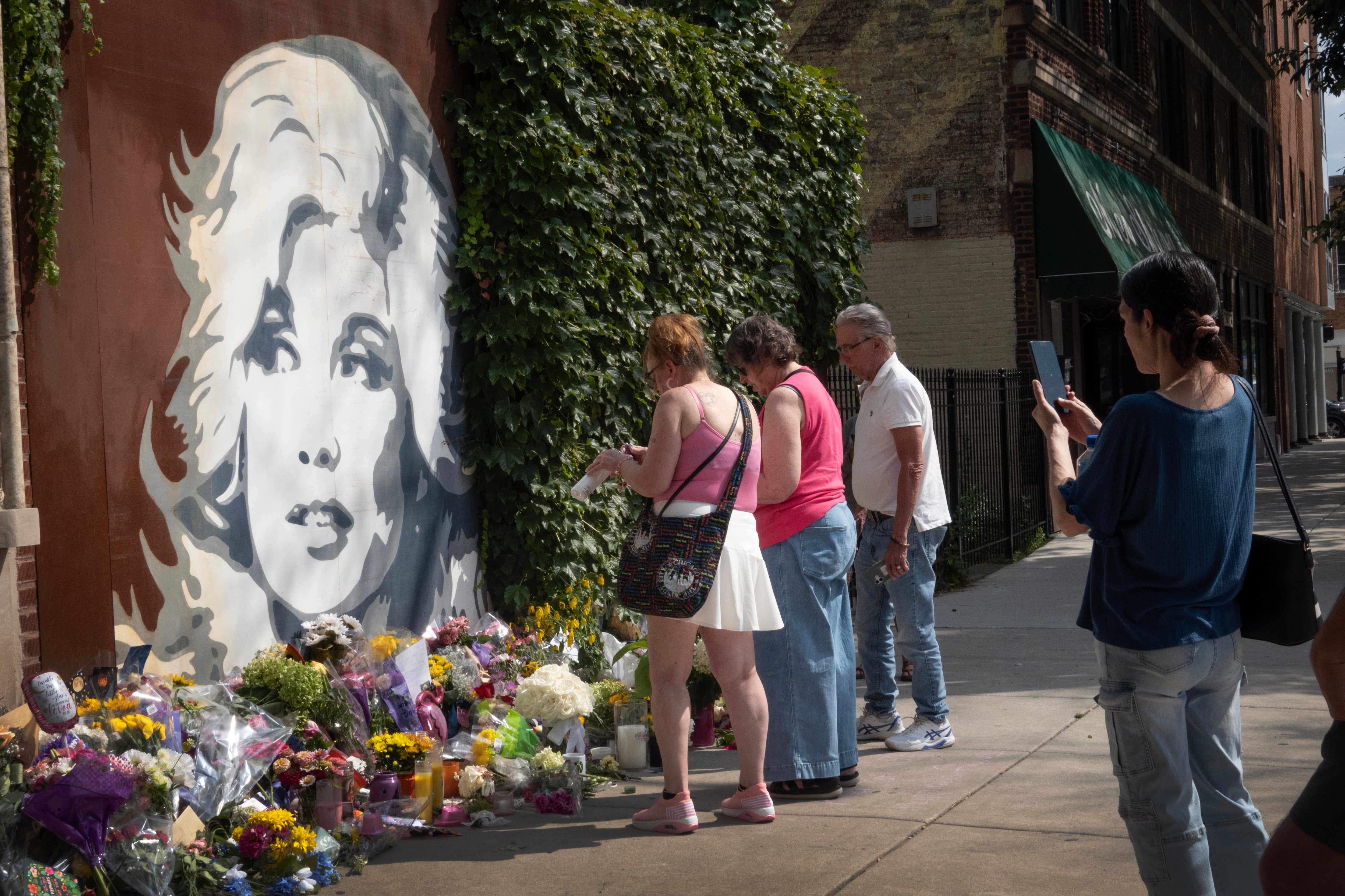 Parton fans visit a mural featuring her likeness in Chicago on Wednesday