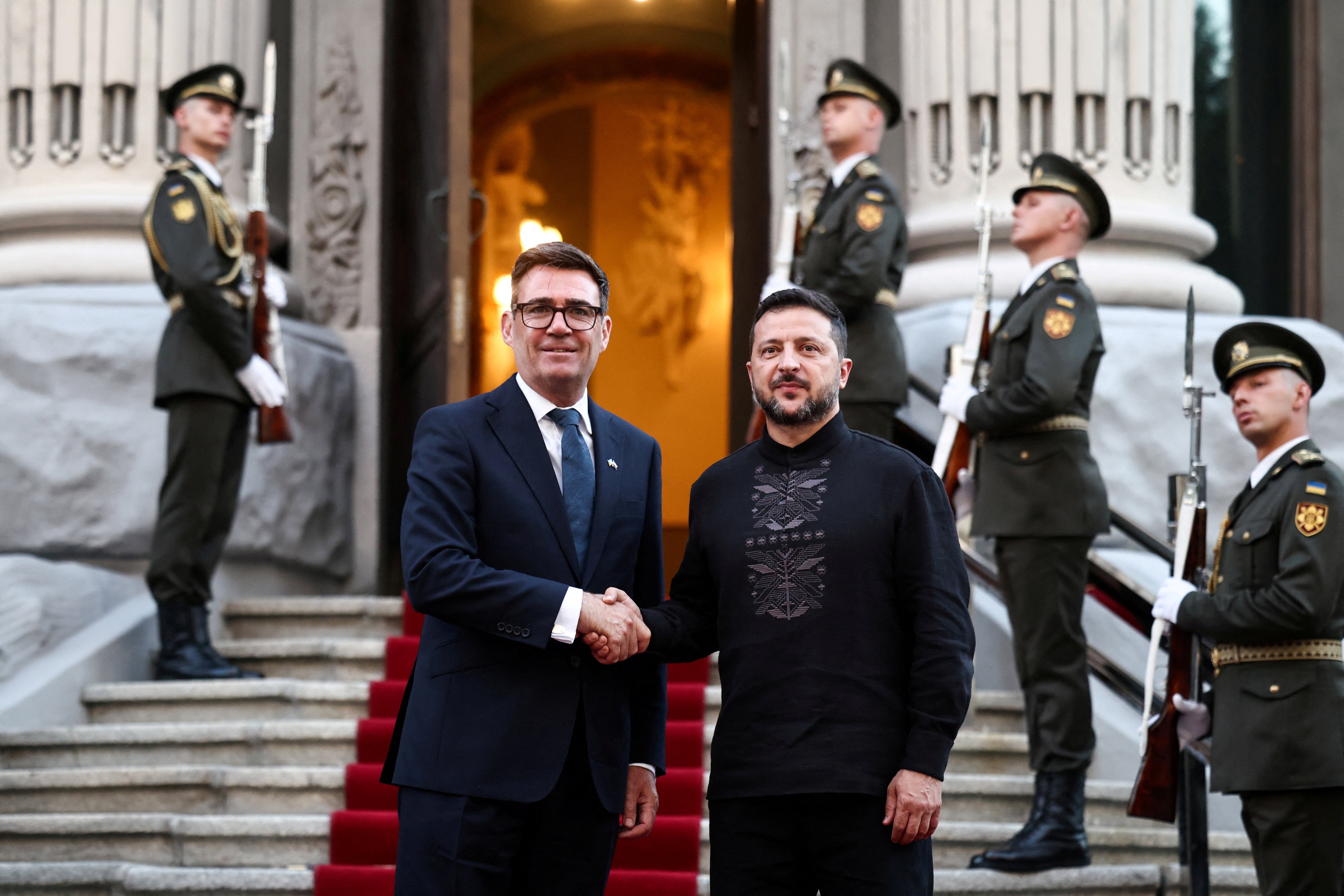 Ukraine's President Volodymyr Zelensky welcomes and shakes hands with British Prime Minister Andy Burnham in Kyiv