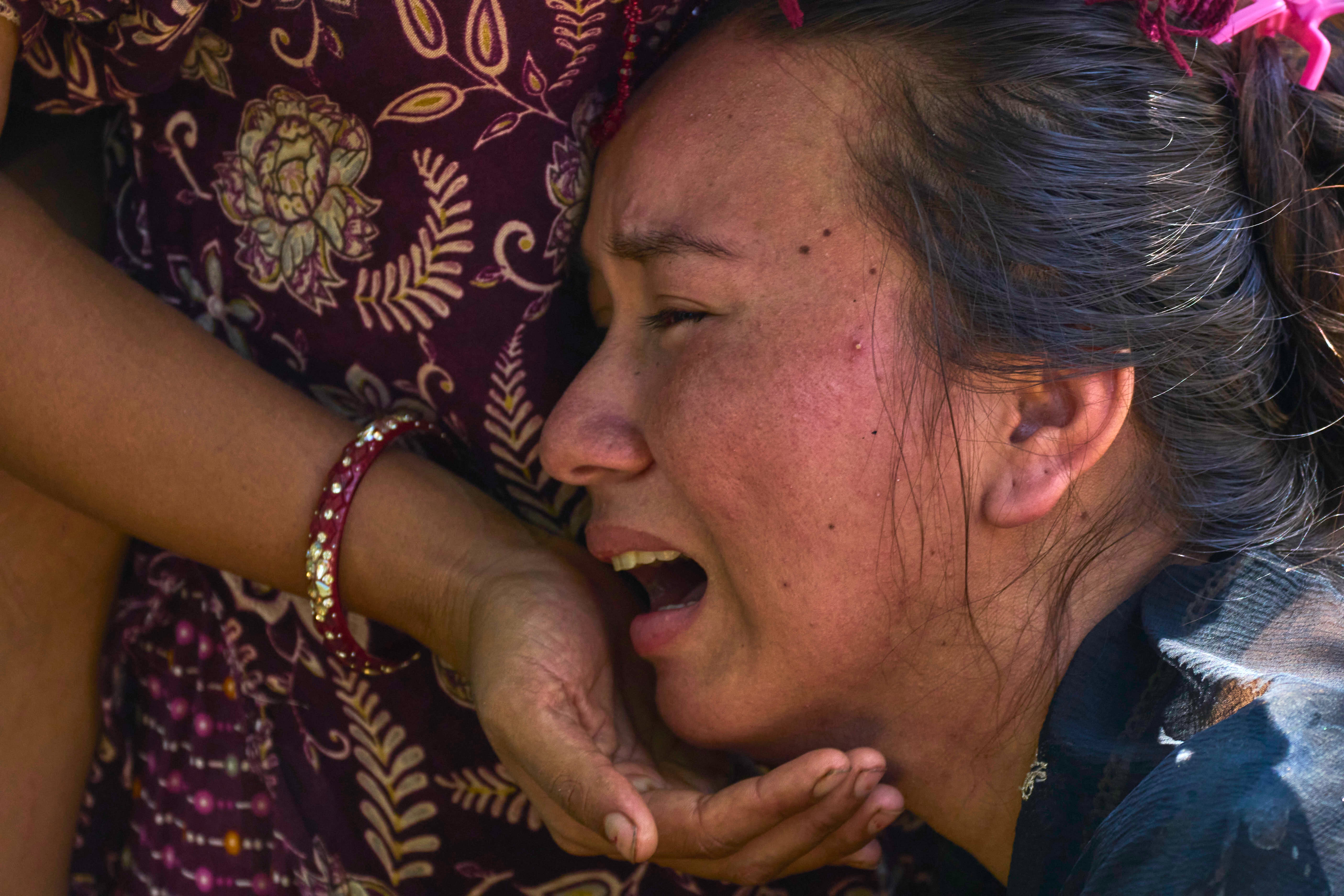 A girl in Bidur, Nuwakot district, waits for news of relatives
