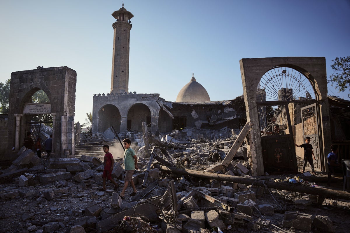 Damaged building collapses in Gaza City, killing at least 12 people