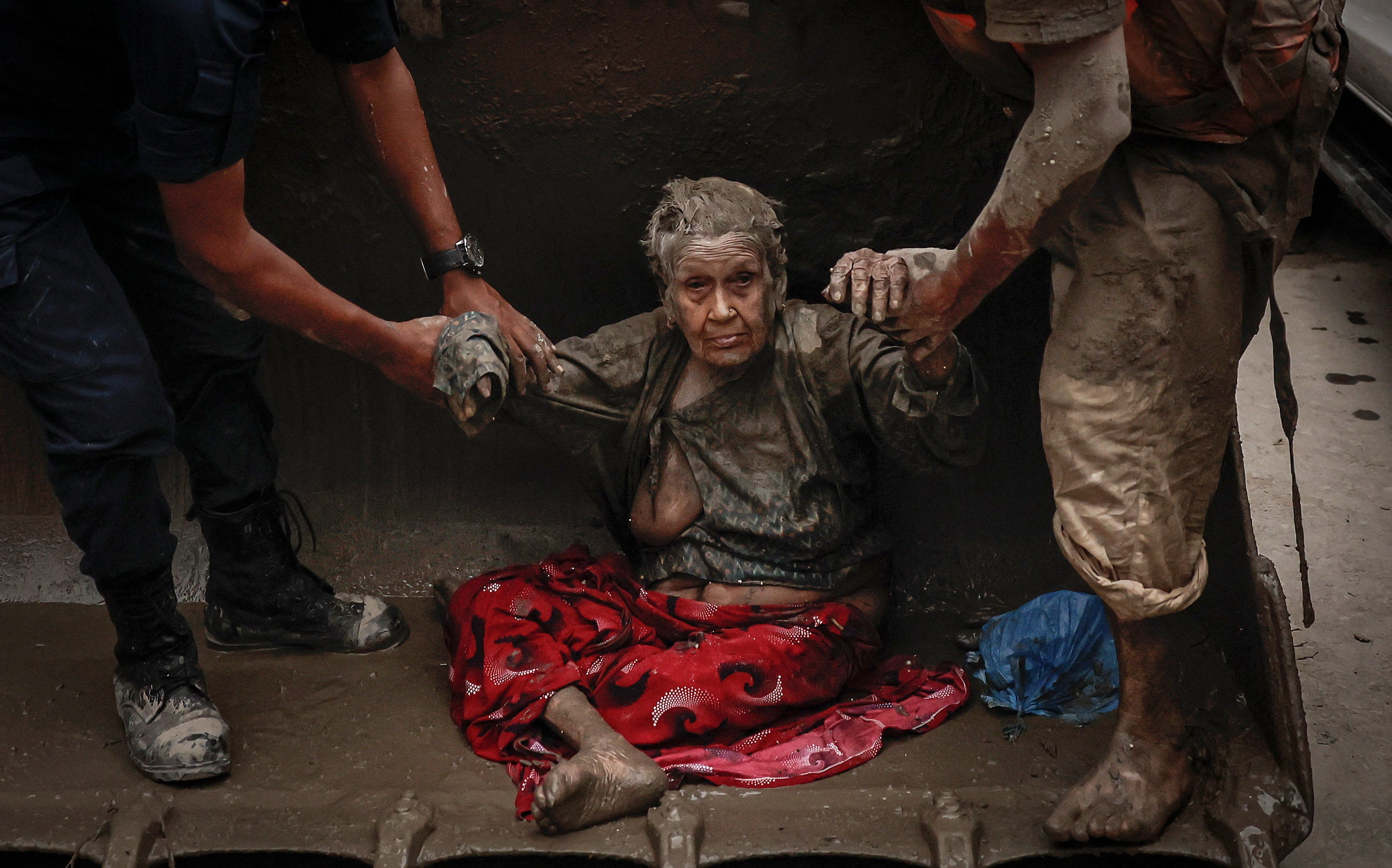 A survivor is transported to a safer place following flash flood and mudslide at Trishuli