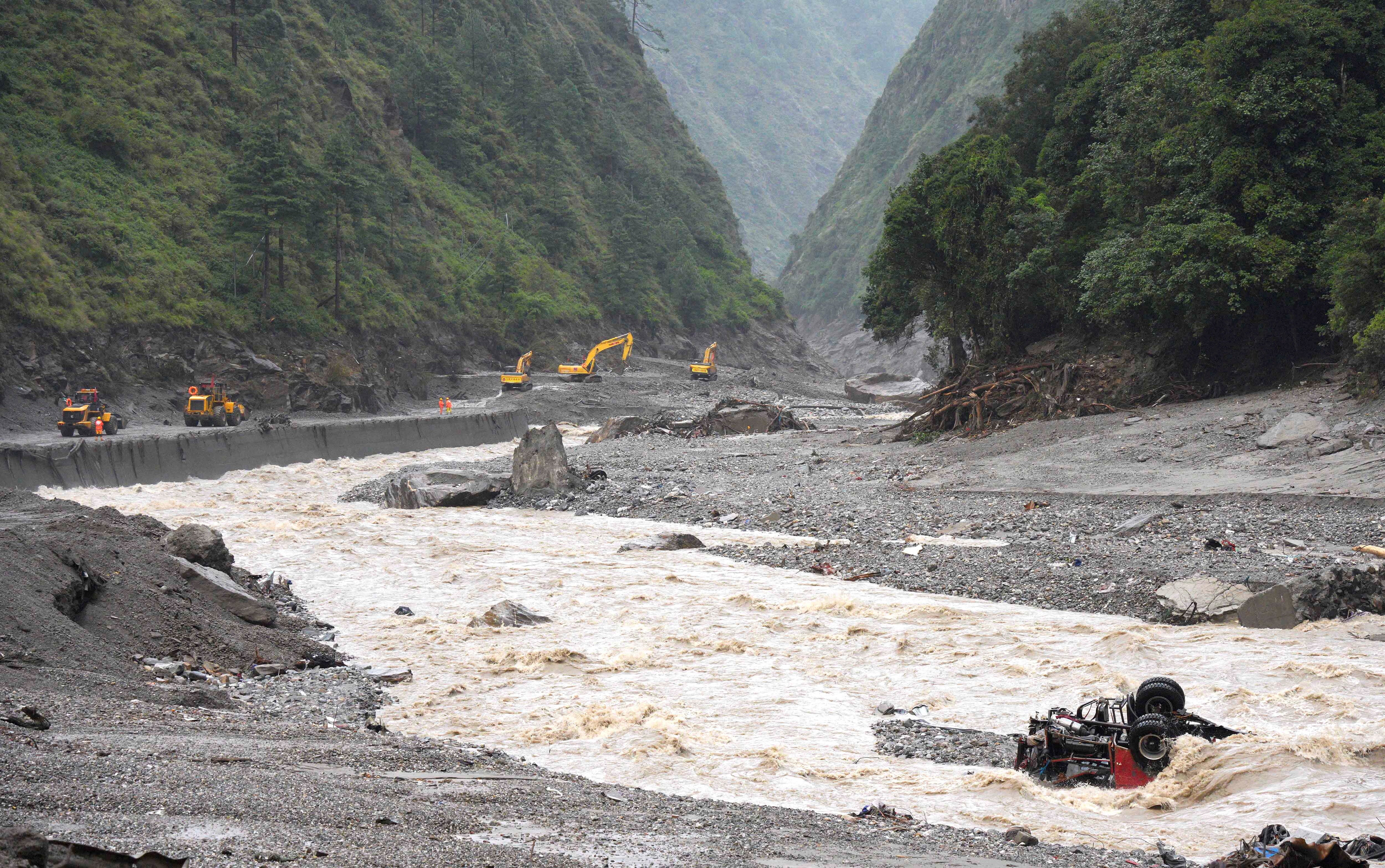 Excavators and loaders in action as rescue workers repair a road leading to Gyirong Port after a mudslide, in Gyirong county, Shigatse, Tibet Autonomous Region, China 28 August 2026